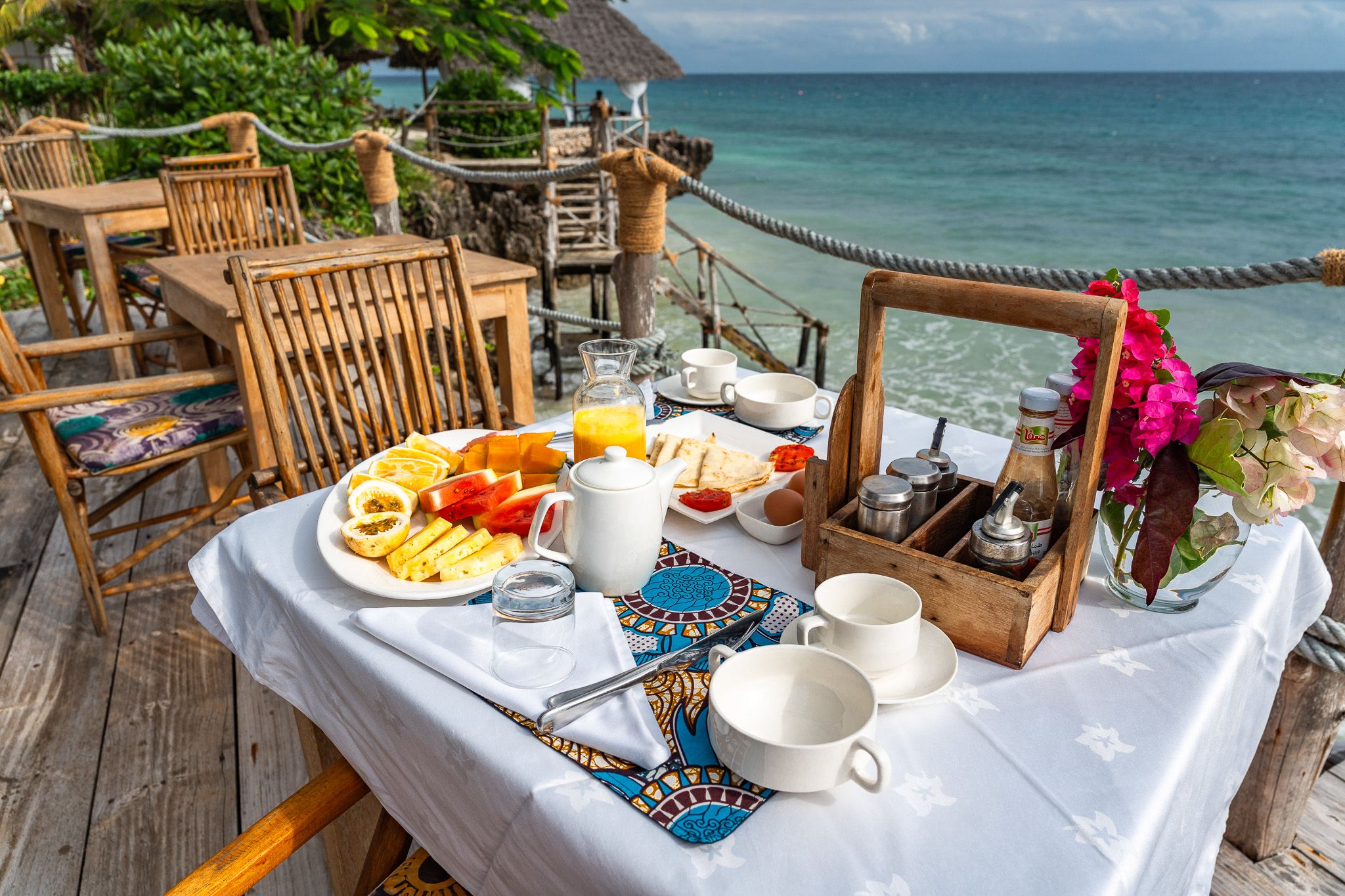 Breakfast table with fresh fruits and ocean view at Zanzibar hotel β lifestyle photography