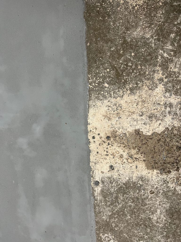 Before and after view showing smooth gray epoxy next to deteriorated concrete surface
