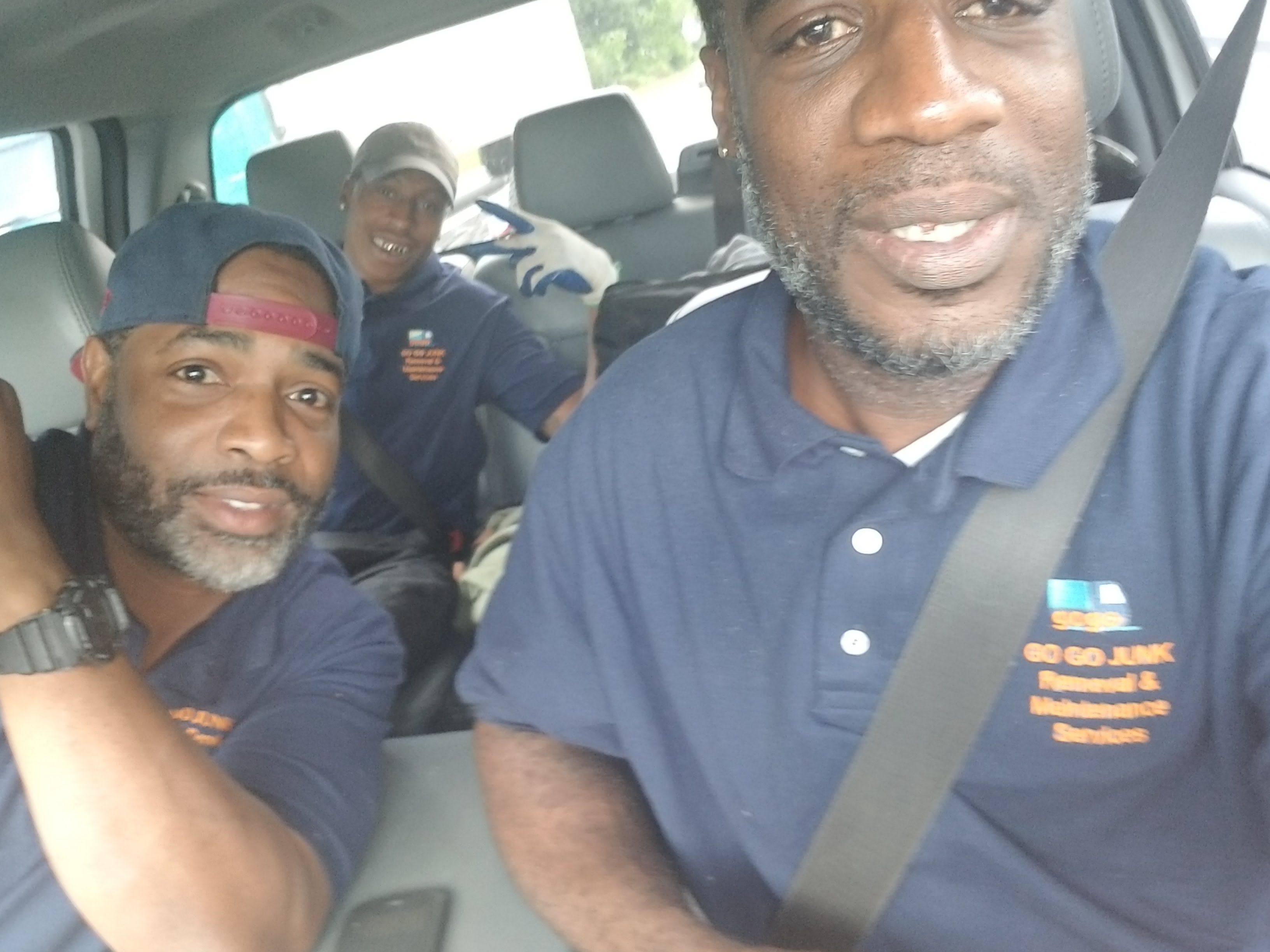 GoGo team in truck - GoGo Junk Removal crew ready for service call in company vehicle
