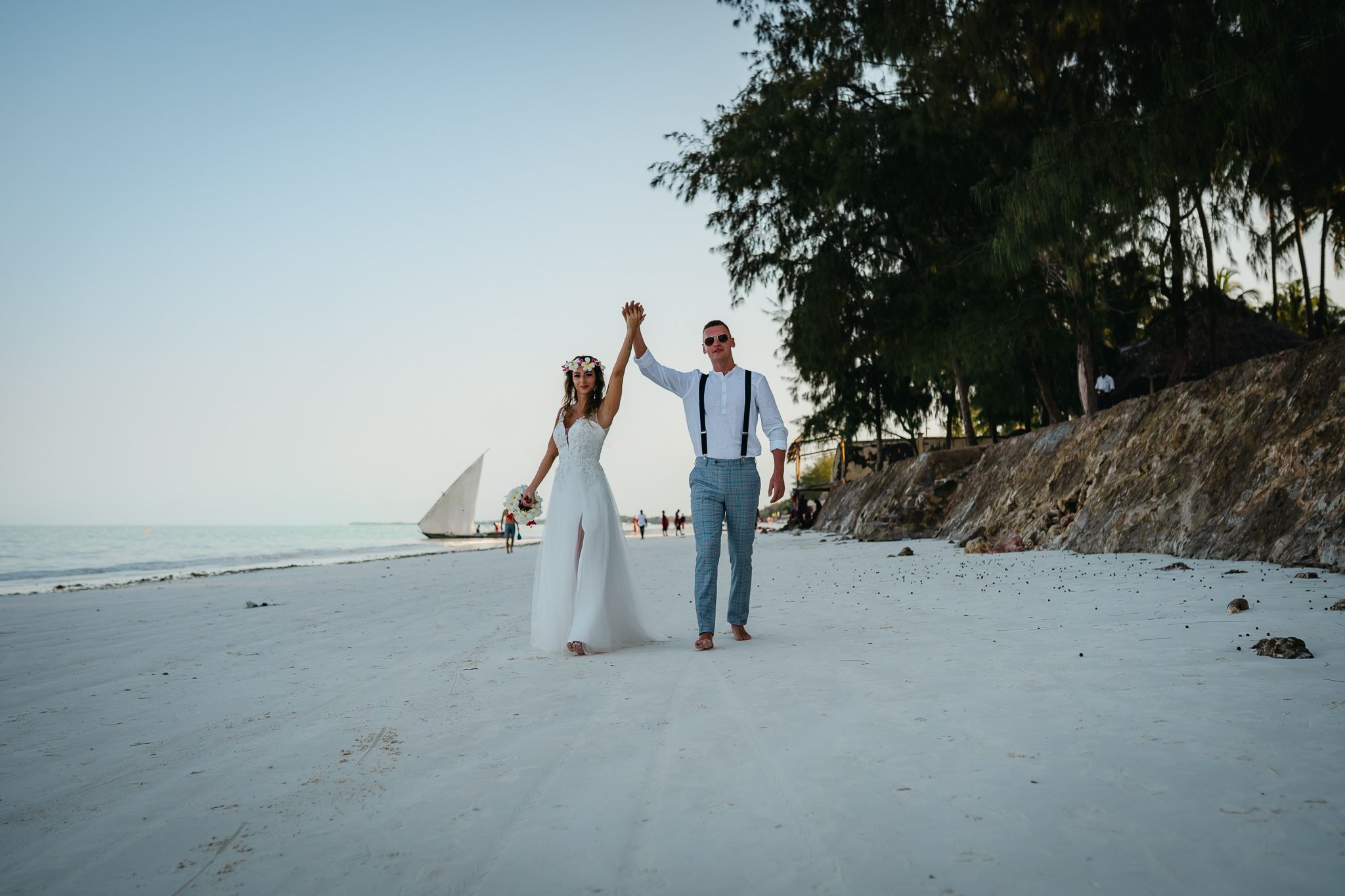 Happy couple walking on Zanzibar beach