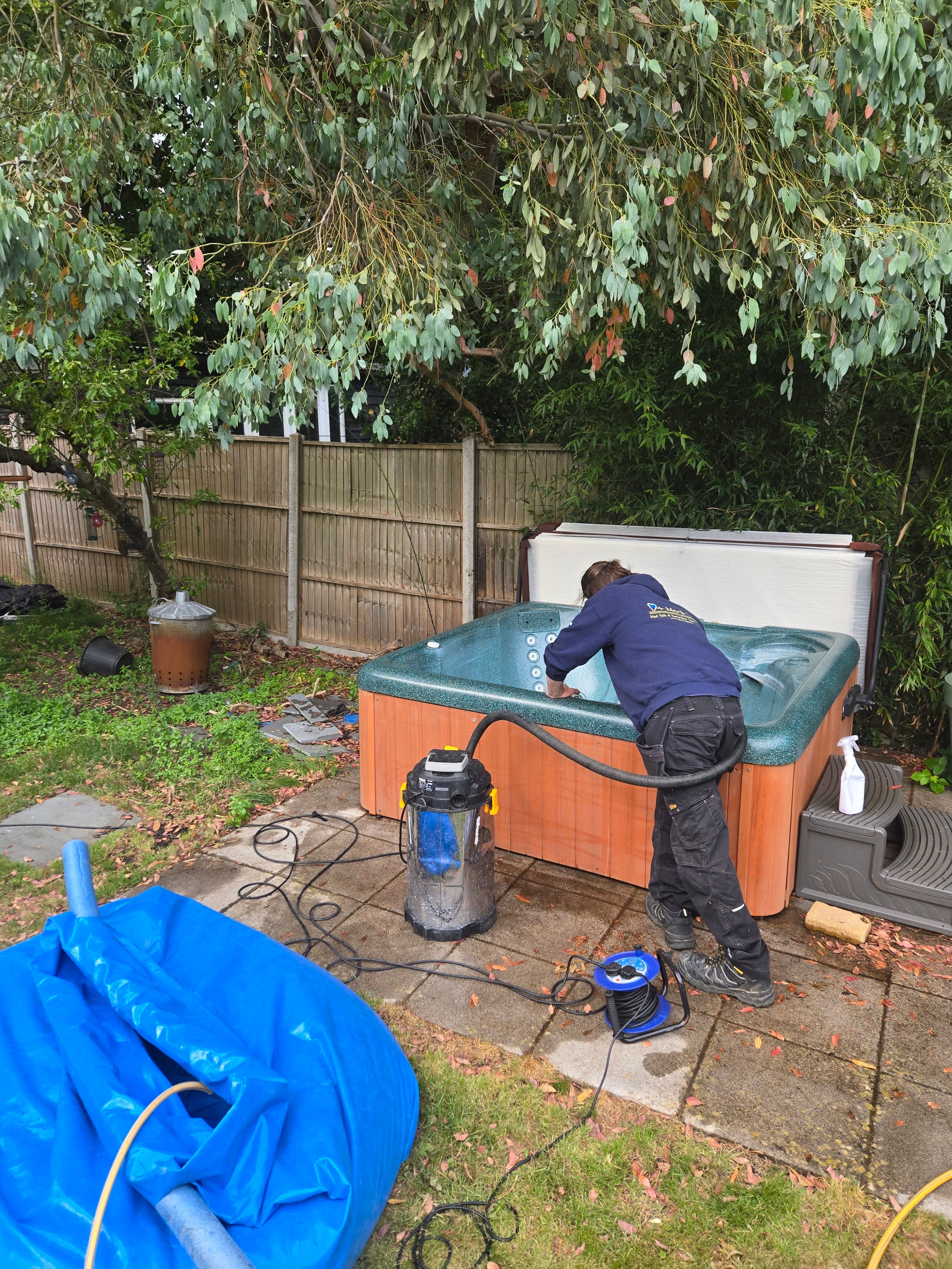 Technician servicing and cleaning a hot tub
