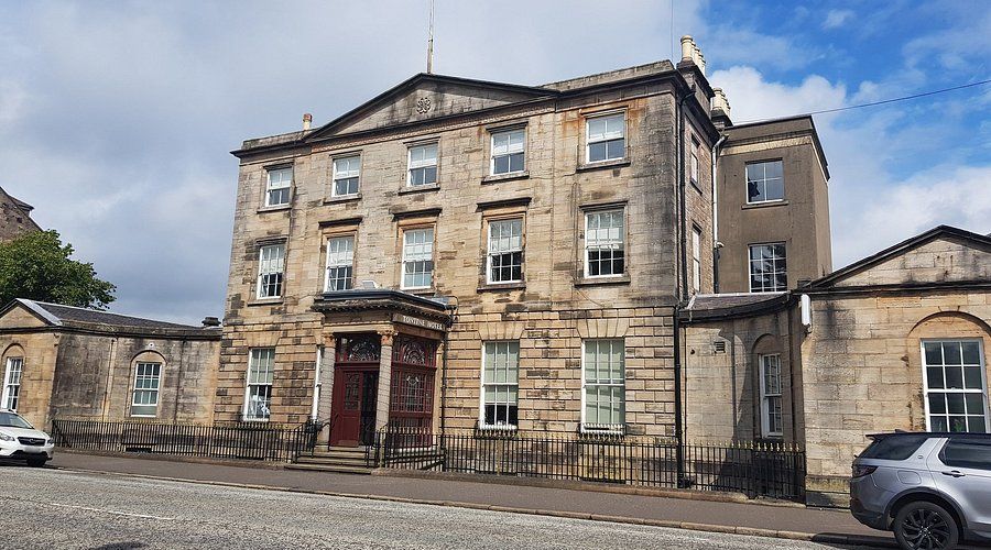 The Tontine Hotel Greenock — a large three-storey stone building with symmetrical facade, columned entrance and arched windows, corporate event venue in Inverclyde, West Scotland