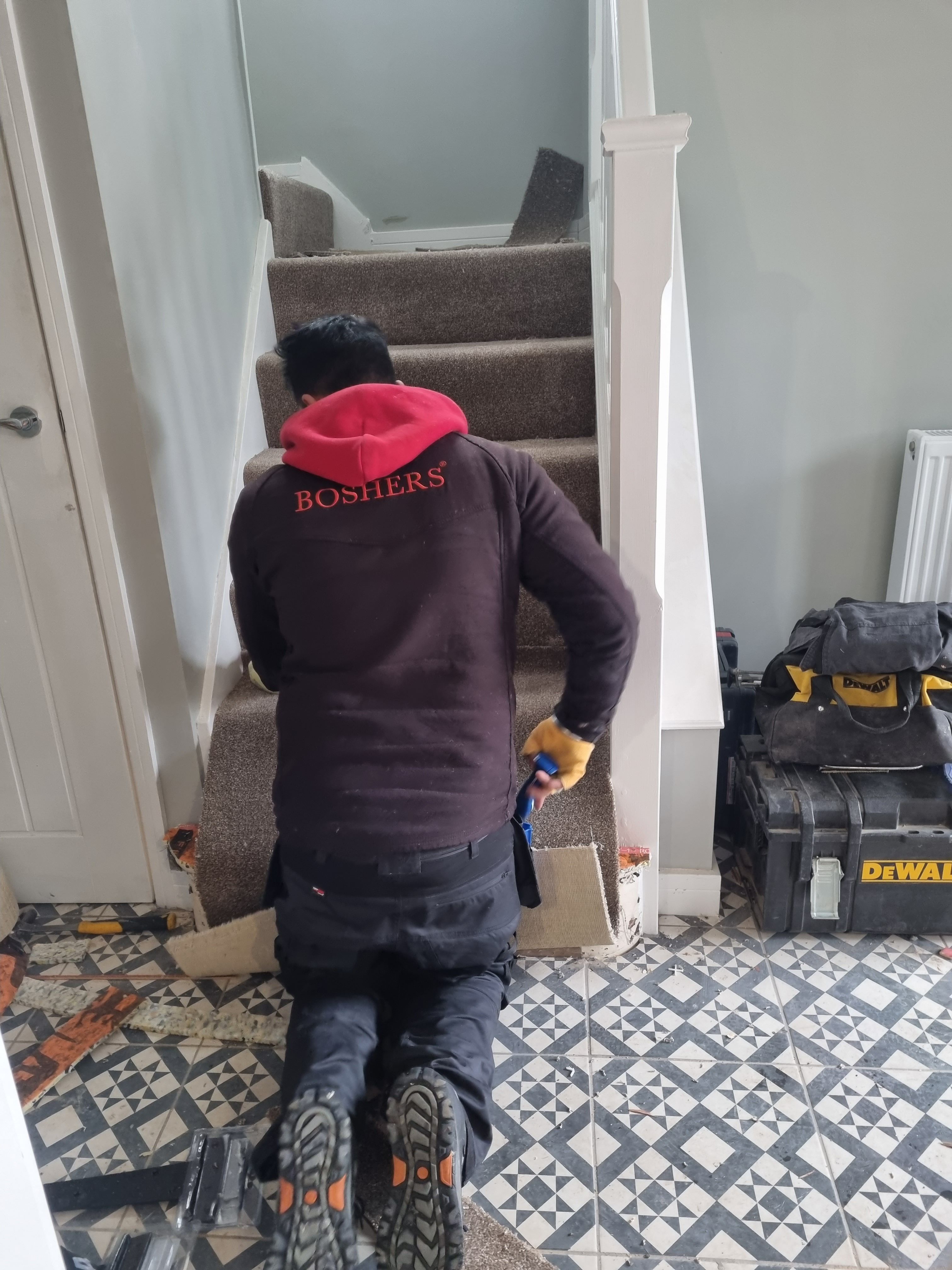 Paris Carpets technician fitting carpet on staircase in Wolverhampton