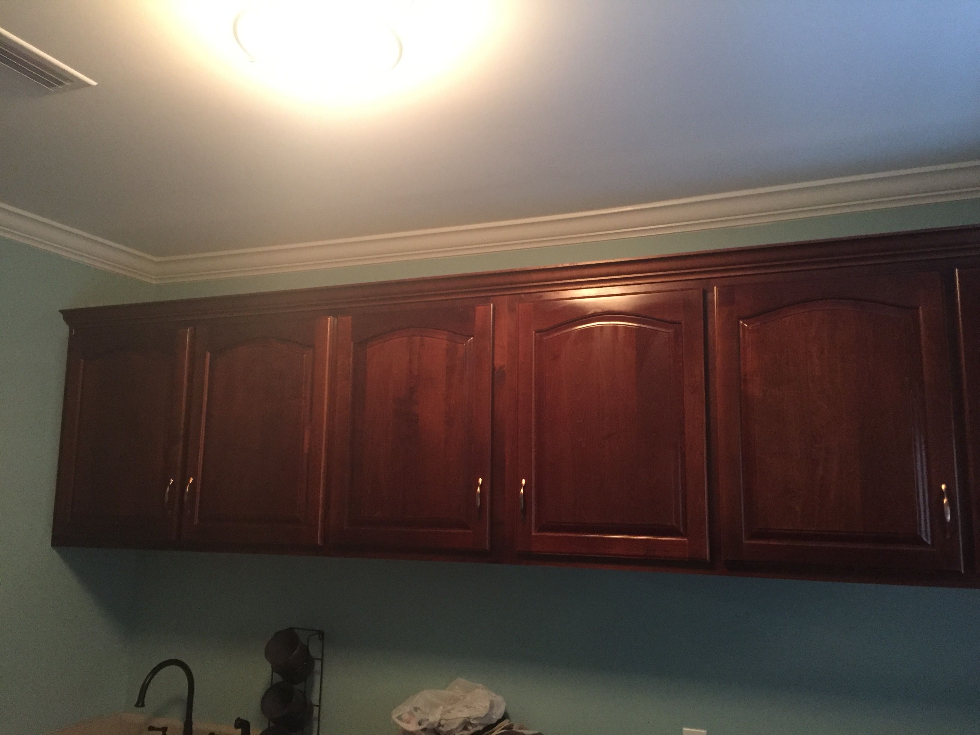 Dark wood bathroom cabinets with arched panel doors