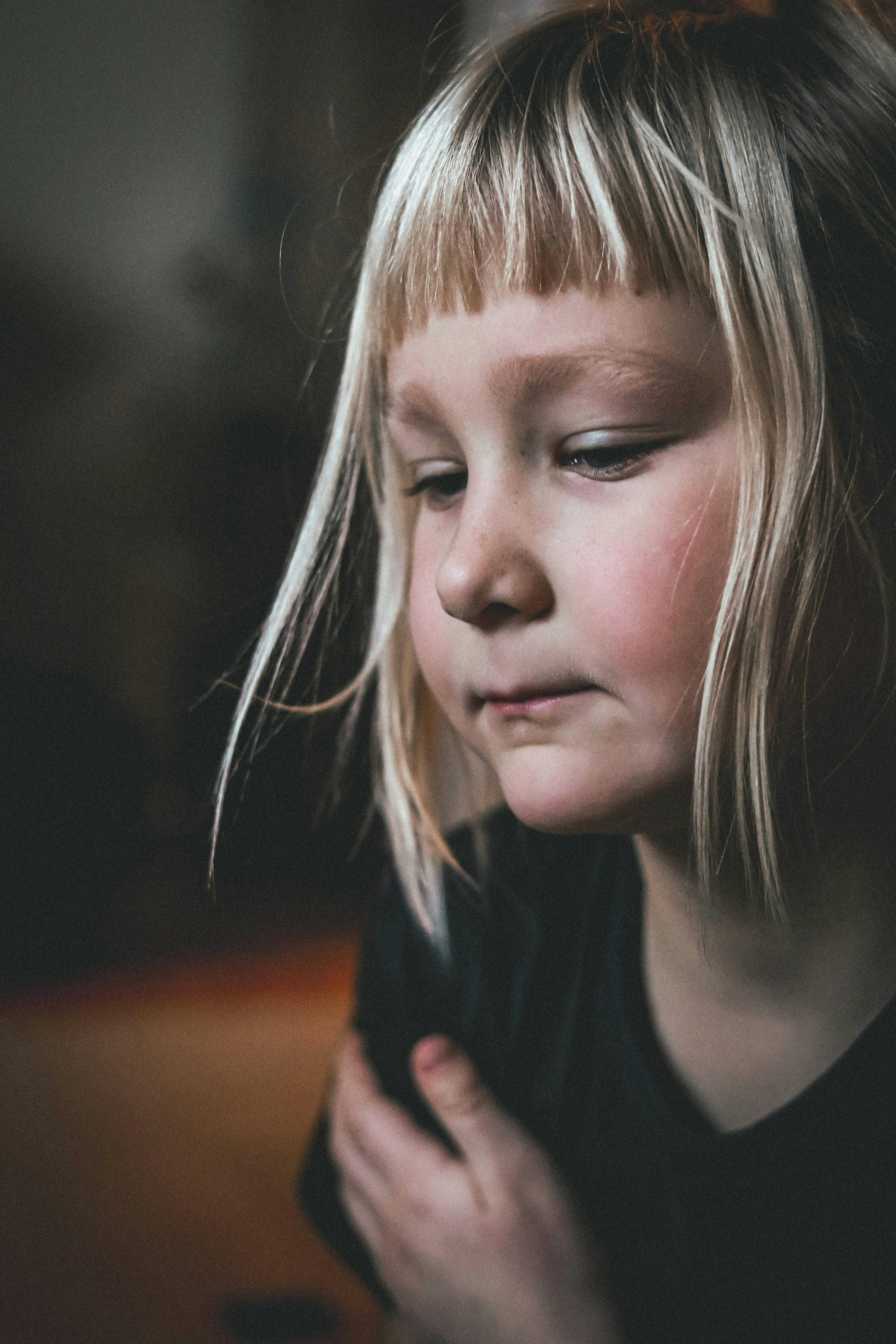 Contemplative young child looking down