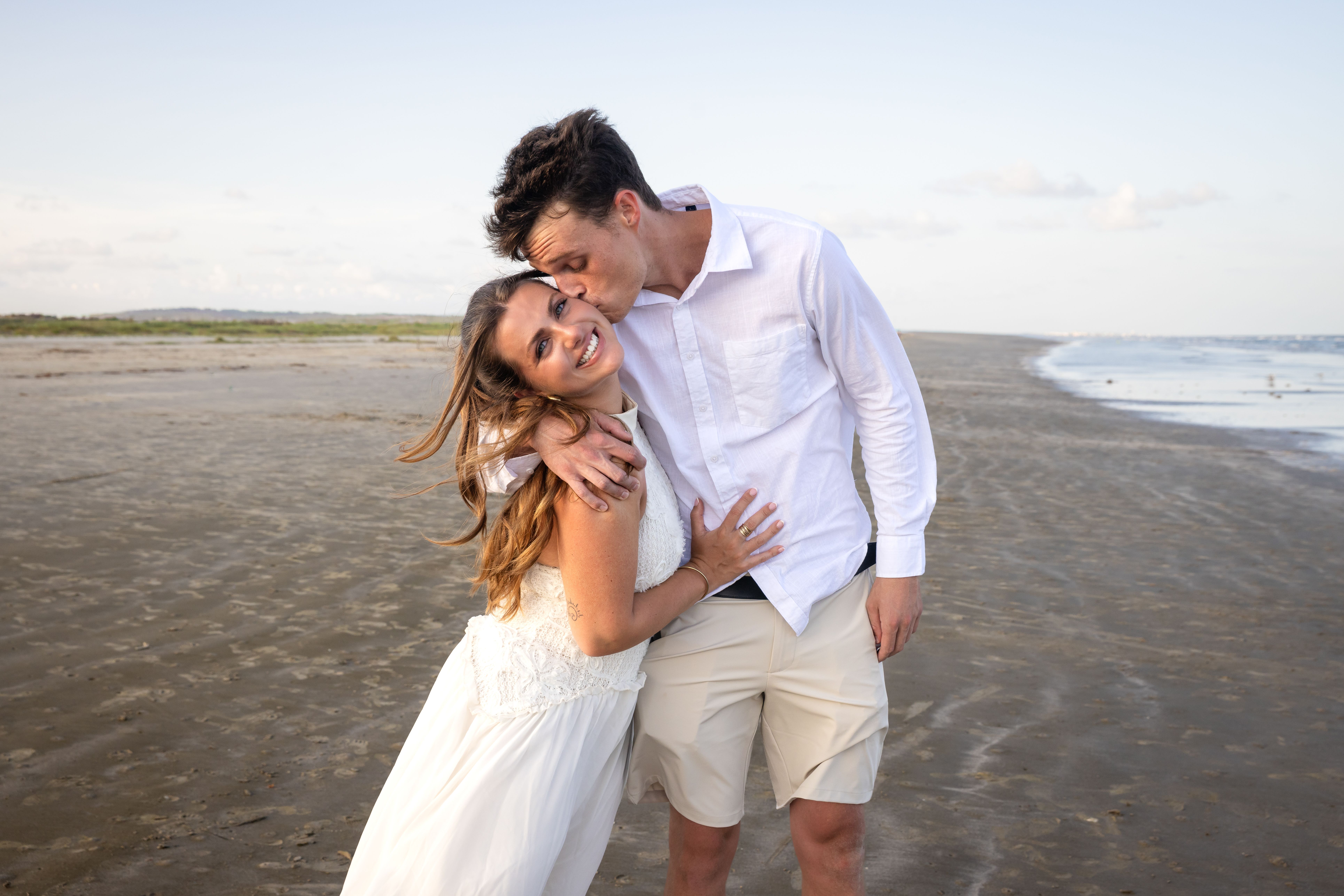 Man kissing woman on the forehead — engagement portraits