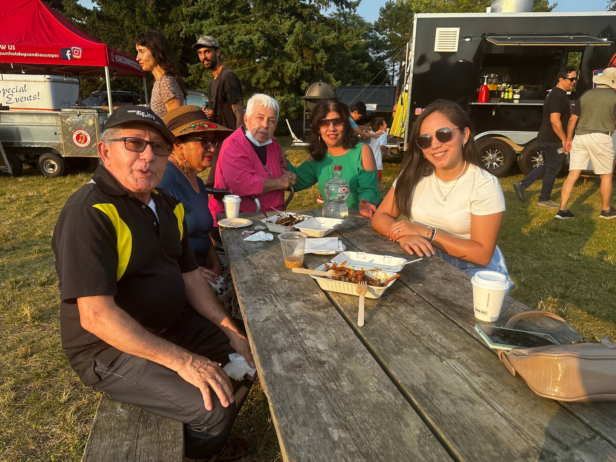 Friends enjoying food at a picnic table