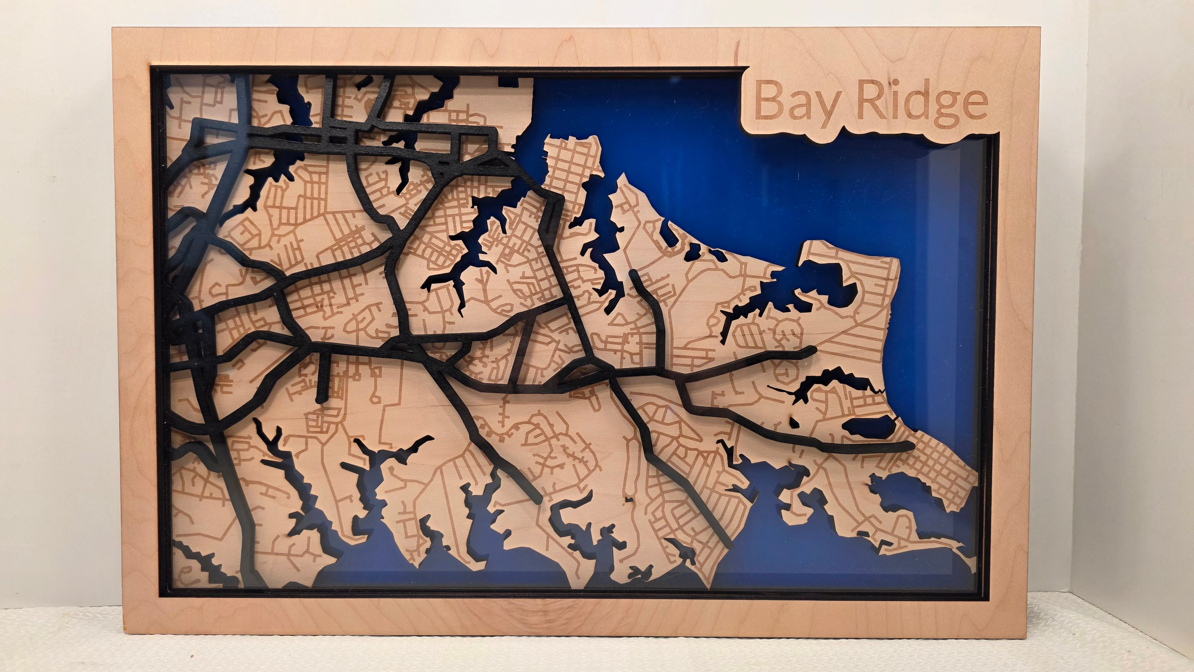 Layered wooden map of Bay Ridge Maryland with blue background