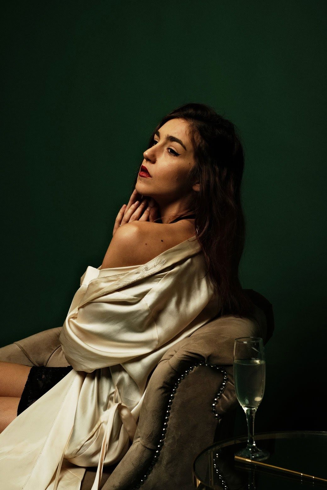 Elegant boudoir with satin robe and velvet armchair