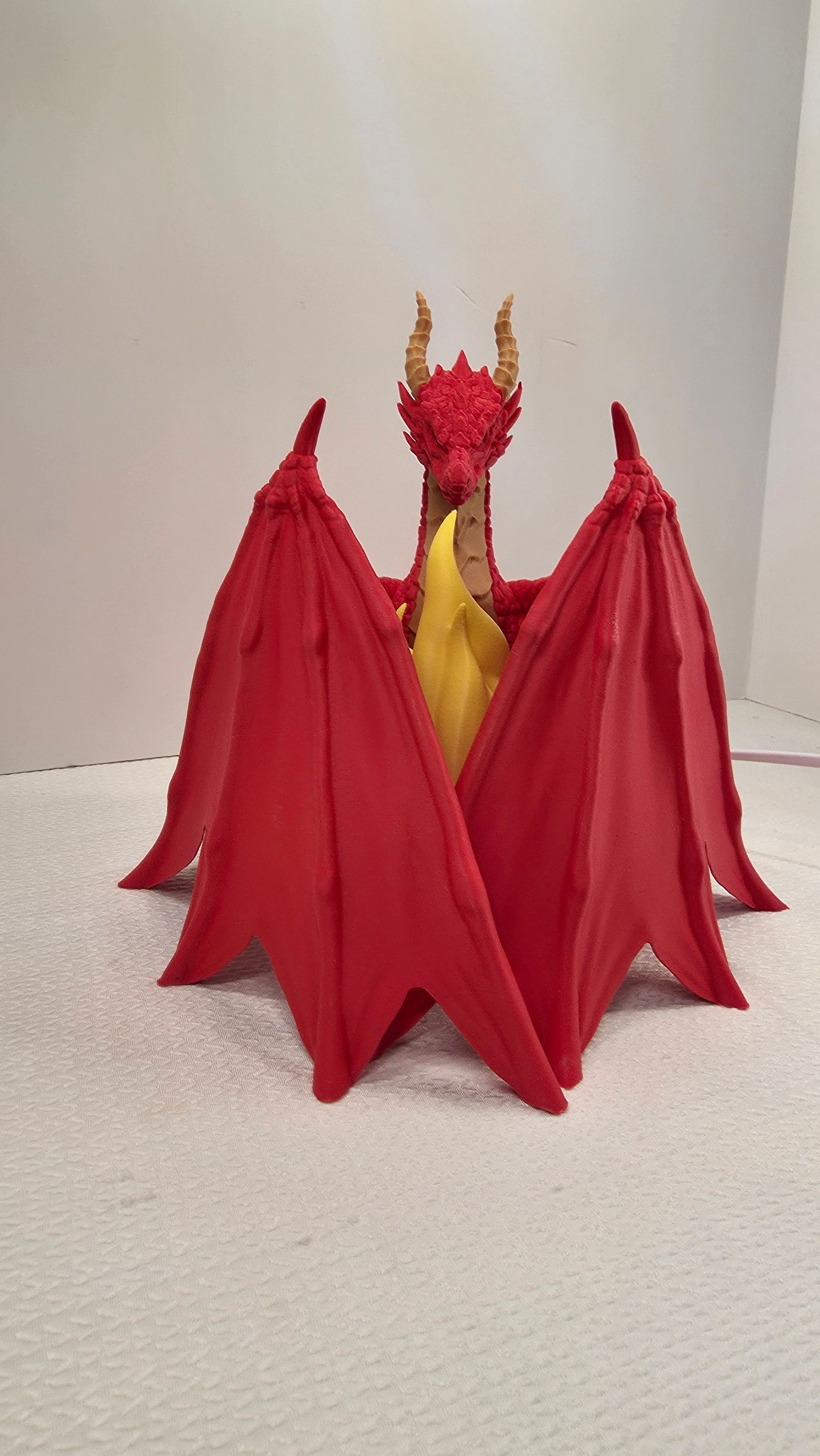 Red dragon holding yellow flame