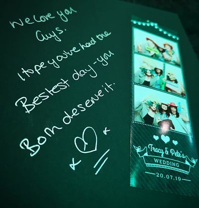 Photo booth guest book with print strip and personal message from a wedding