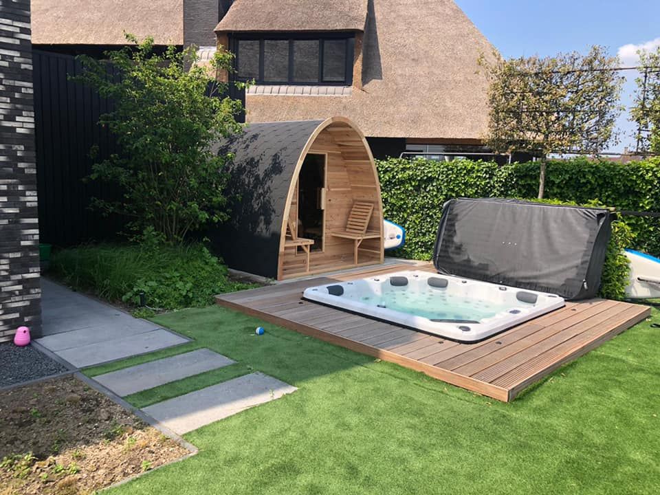Hot tub installed on a wooden deck in a beautiful garden setting