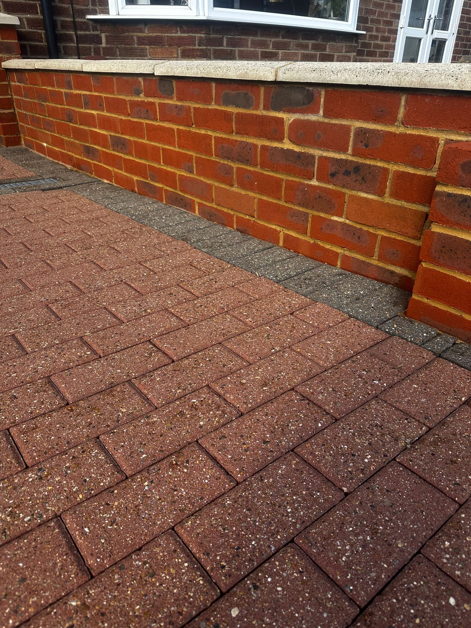 Cleaned block paving and brick wall area
