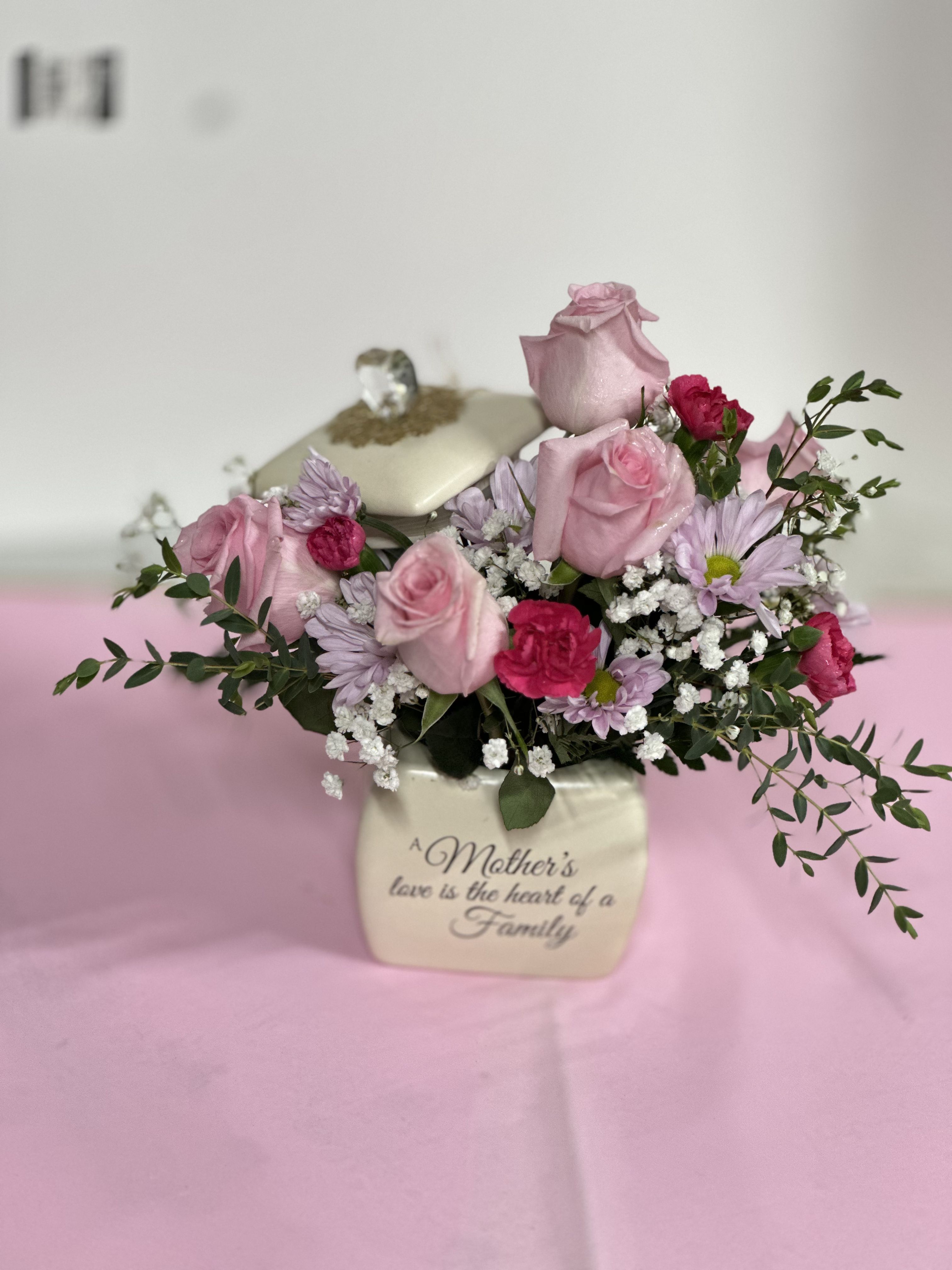 Pink and red roses arrangement in cream vase