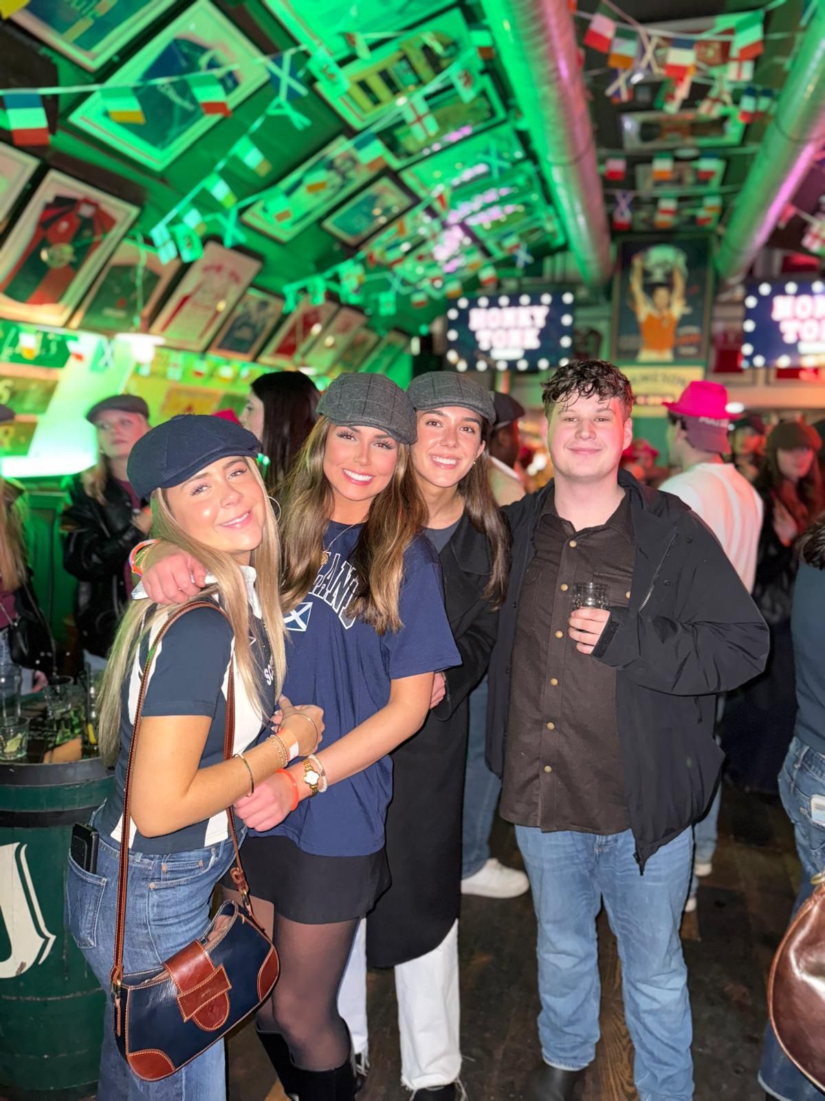 Friends posing with drinks at one of the 5 bars on the Ebrius Glasgow bar crawl route