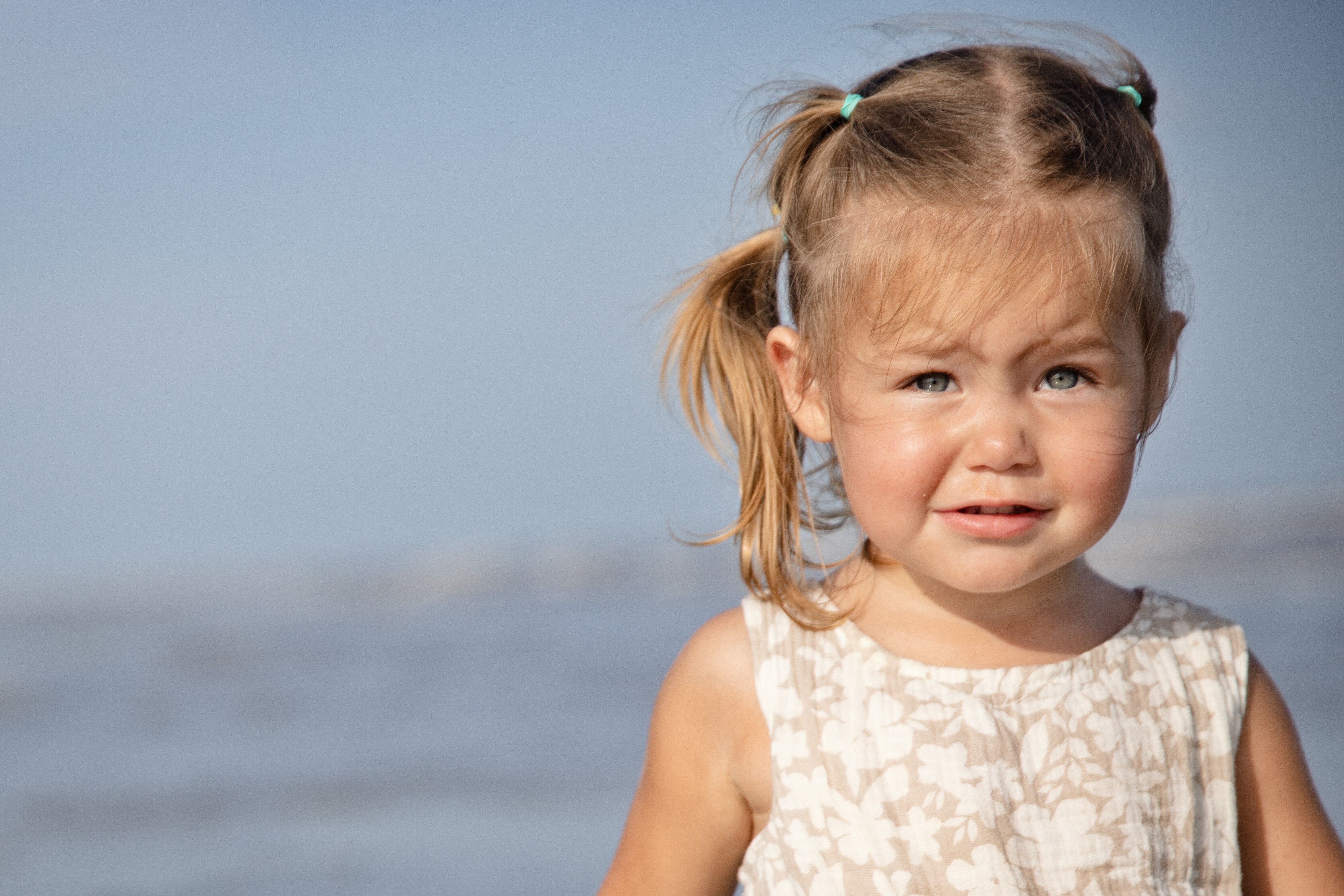 Close-up portrait of a little girl with blue eyes