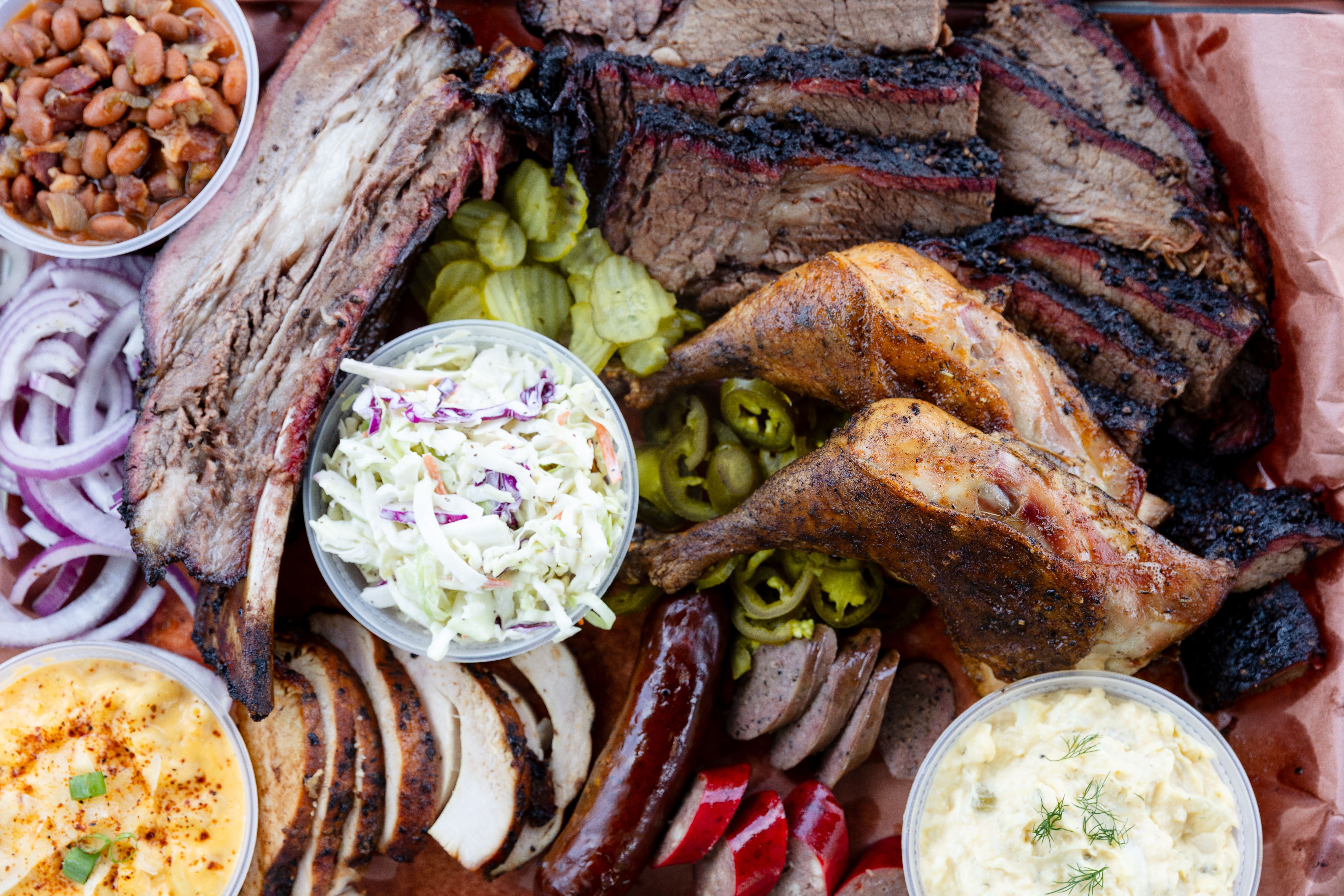 BARK'D BBQ smoked brisket, chicken, sausage and beef ribs on a full platter