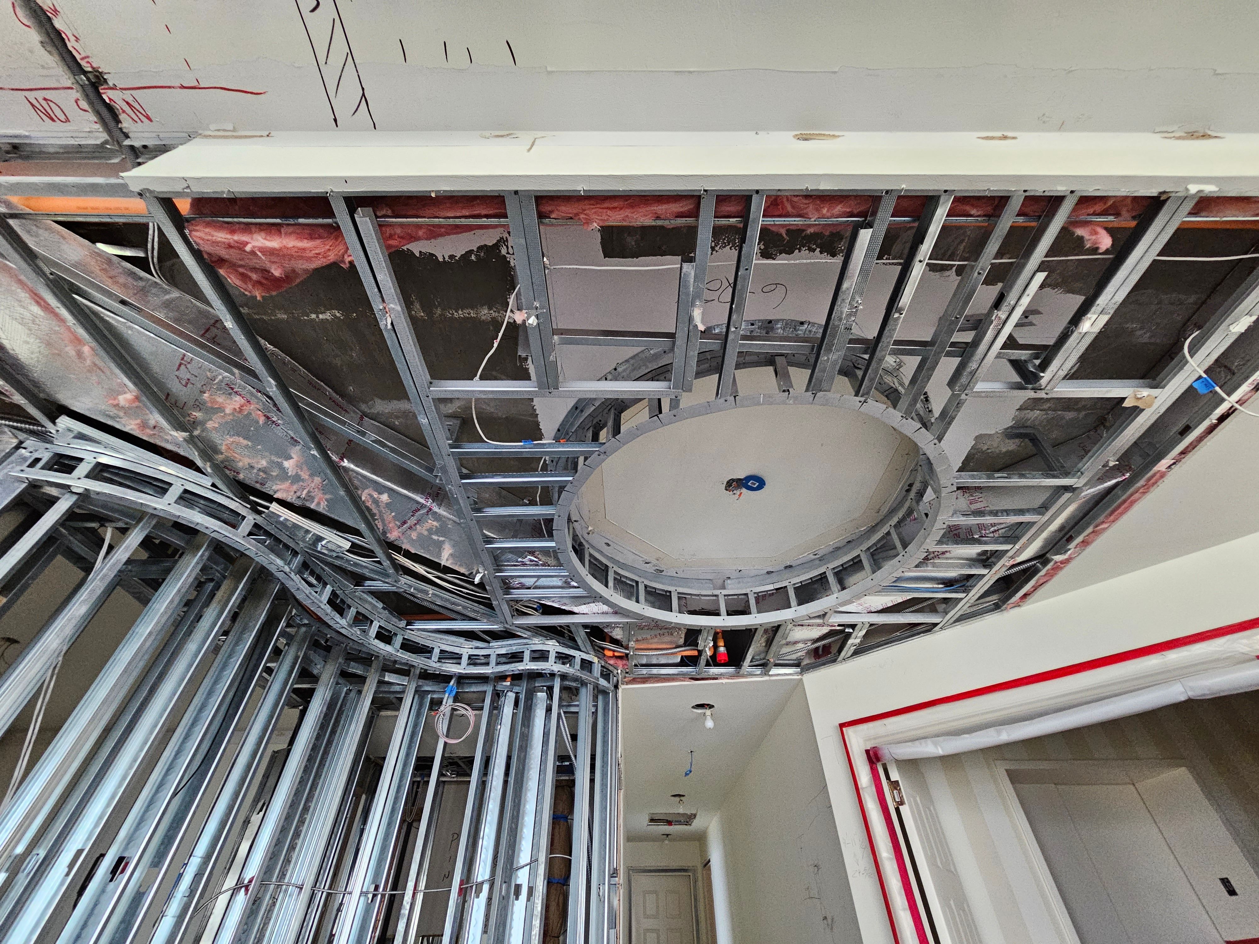 Metal framing and insulation during a ceiling and wall build-out