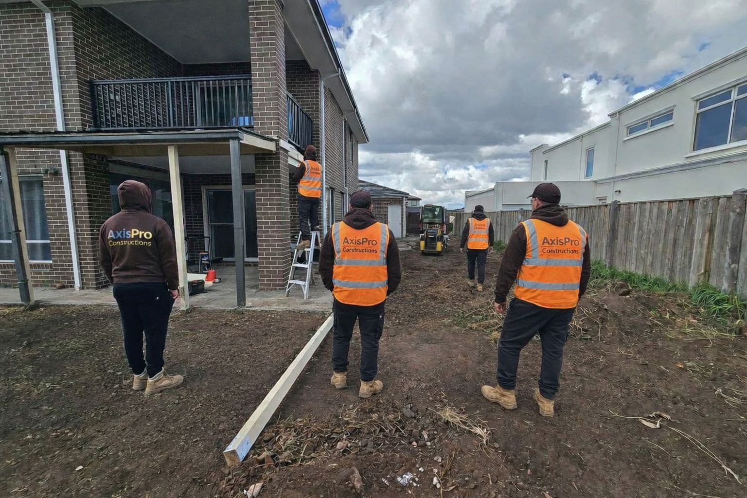 AxisPro Constructions team on site wearing branded uniforms and safety vests