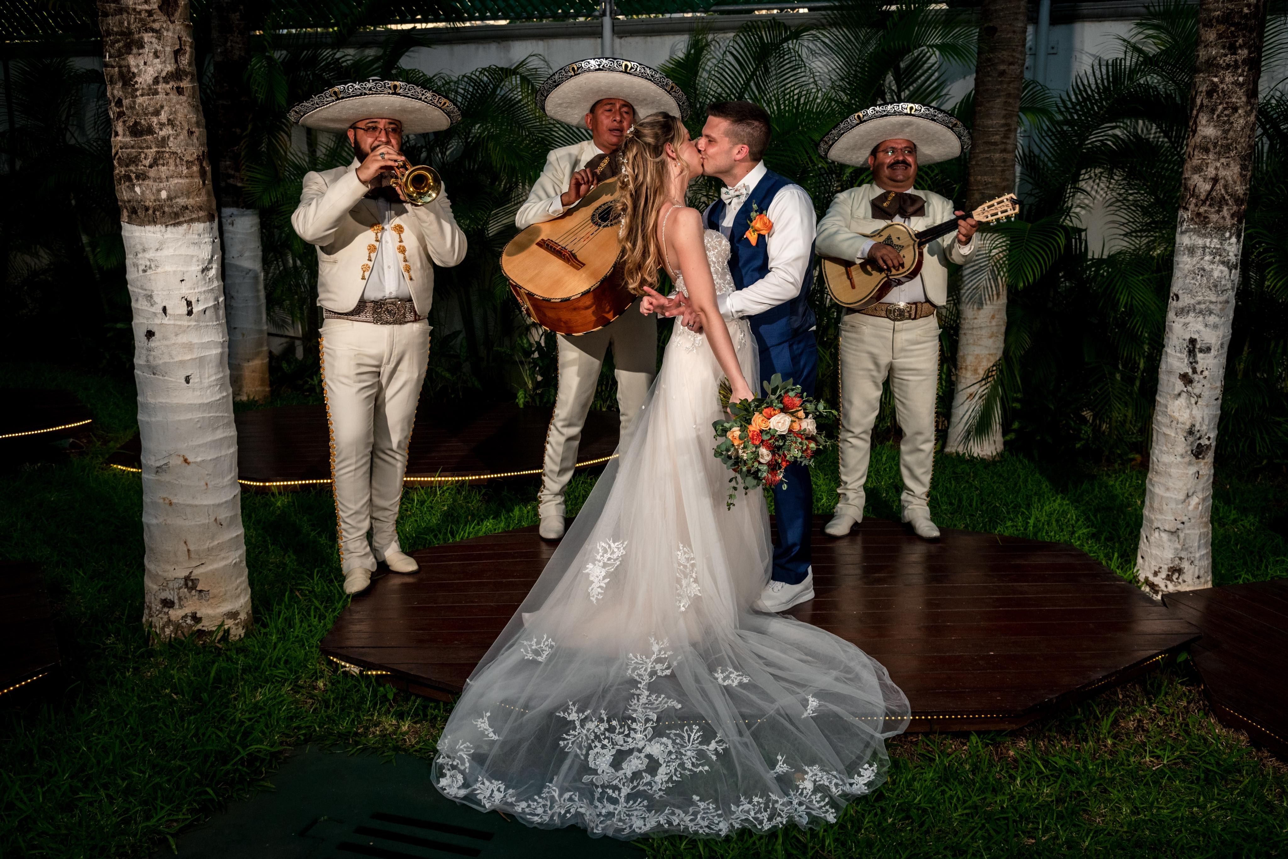 Bride and groom at wedding with mariachi band