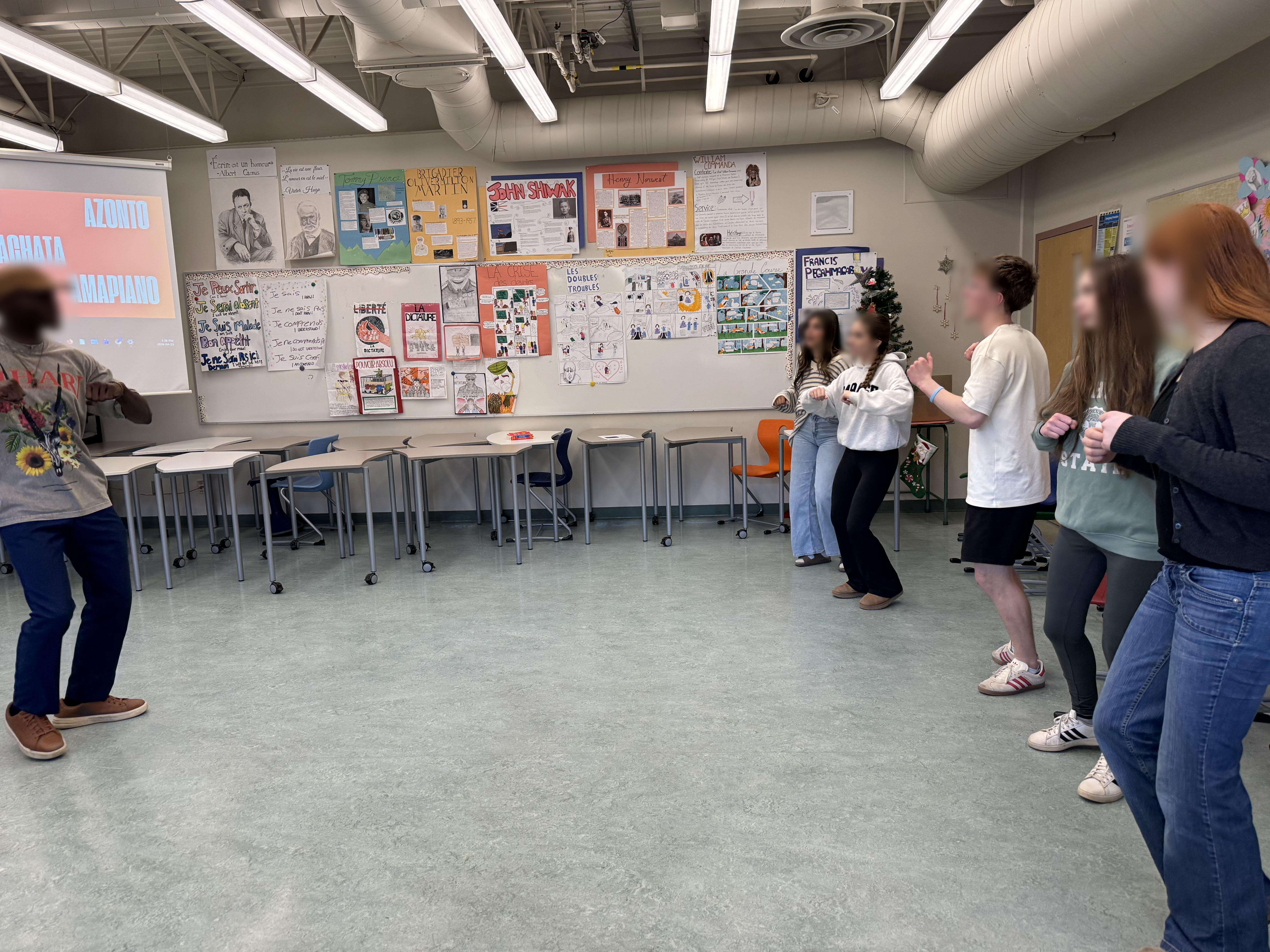 Ivan facilitating a rhythm workshop with students in a classroom
