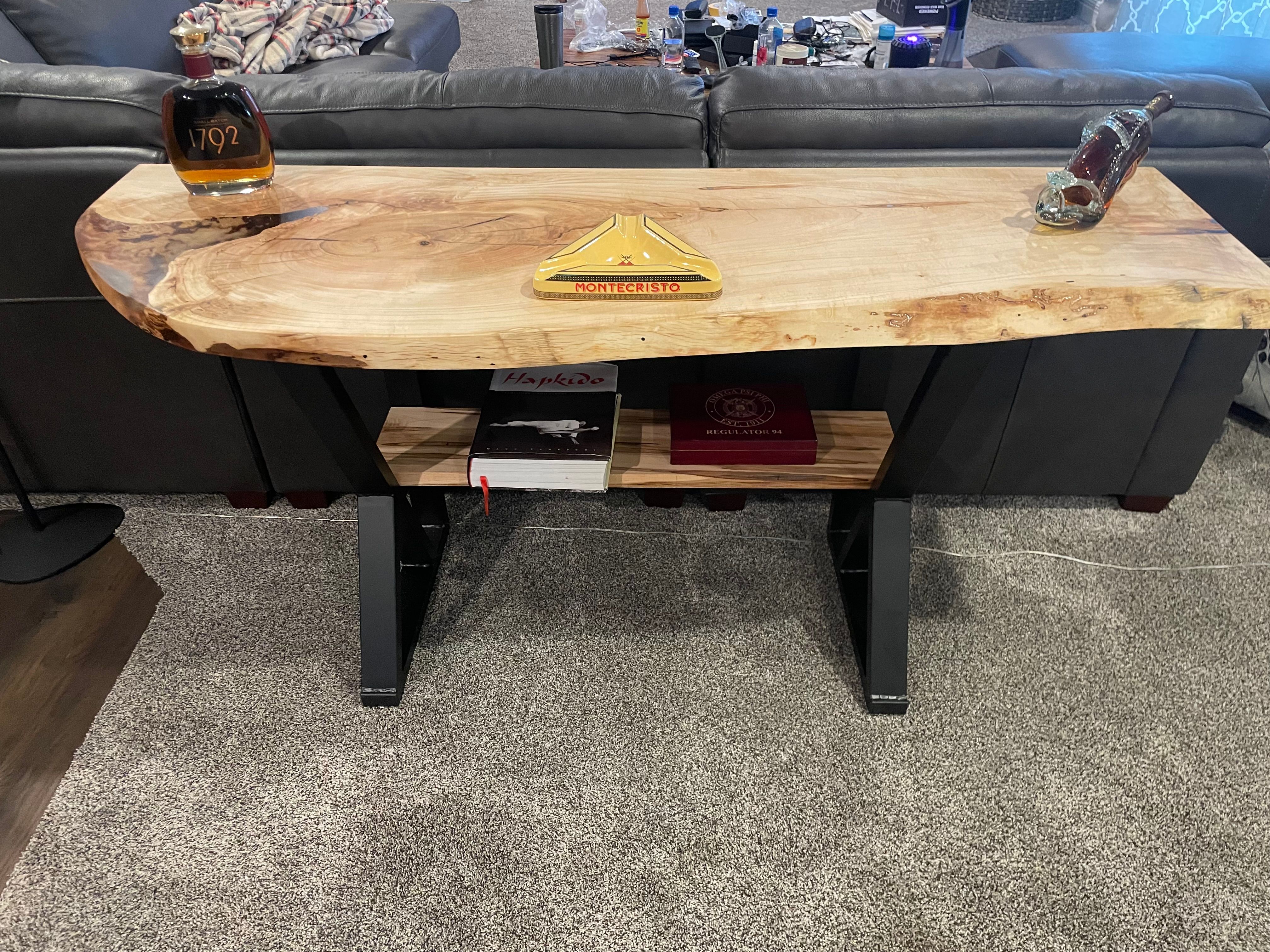 Live edge table with lower shelf displaying books