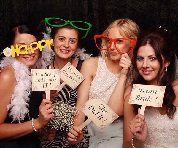 Wedding guests with props in the Pose Photo Booth