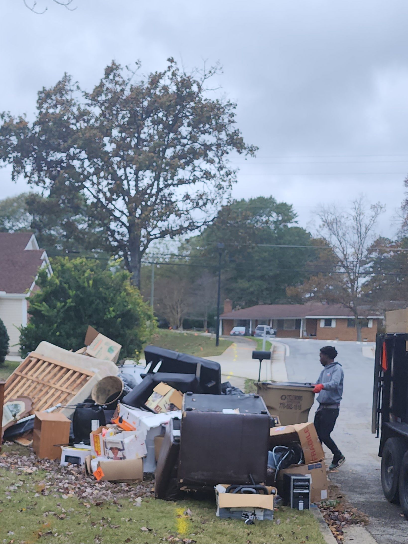 GoGo Junk Removal team member at curbside cleanout job in Covington