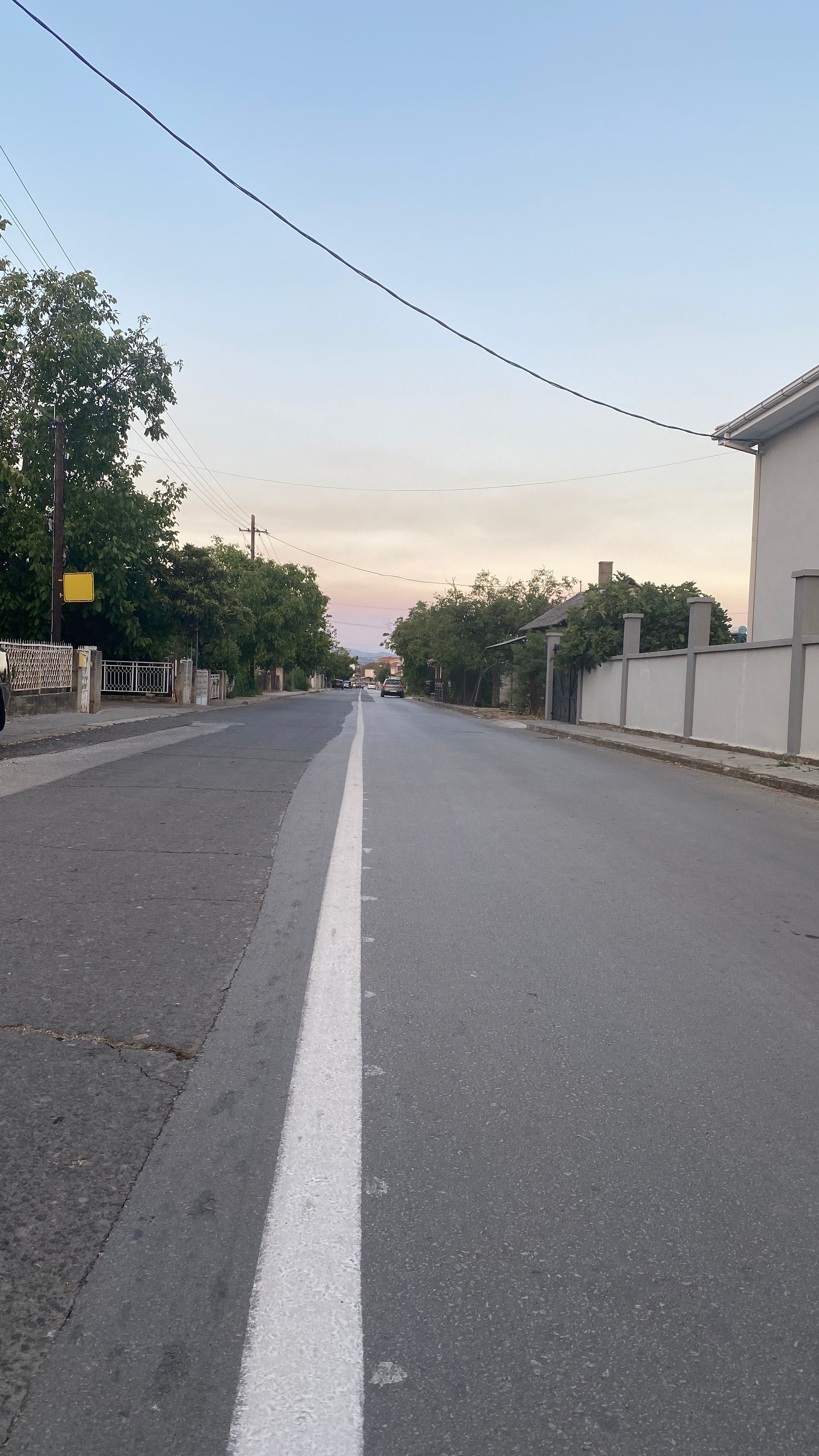 A straight road stretching into the distance under a clear sky