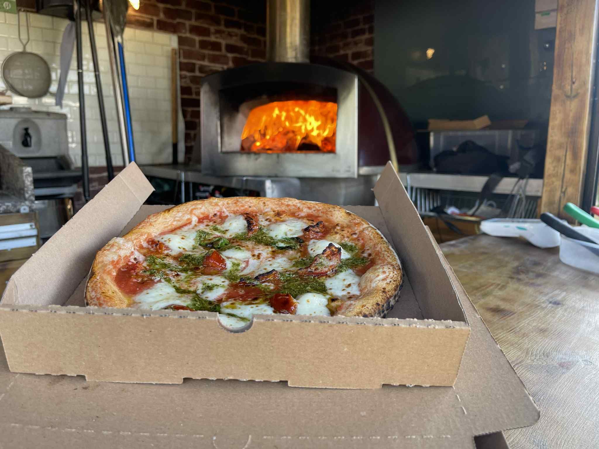 Fresh pizza with mozzarella and basil from the wood-fired oven
