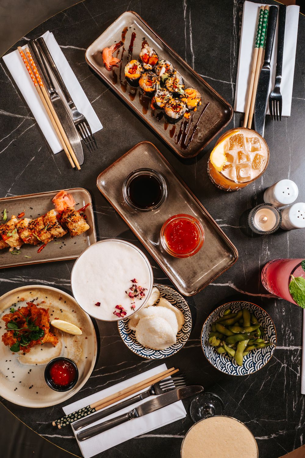 Table spread of Pan-Asian dishes and cocktails at Bambuu Bournemouth