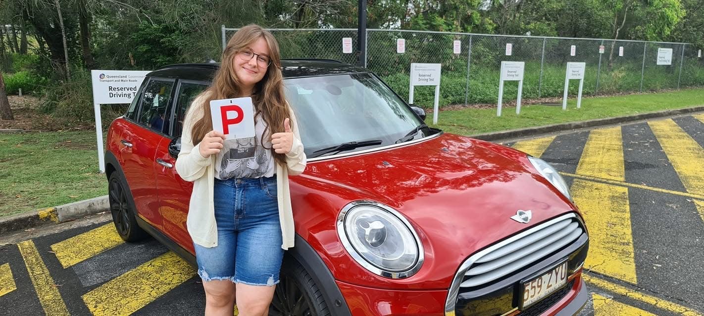 Molly celebrating after passing her Gold Coast driving test with RED Driver Training instructor