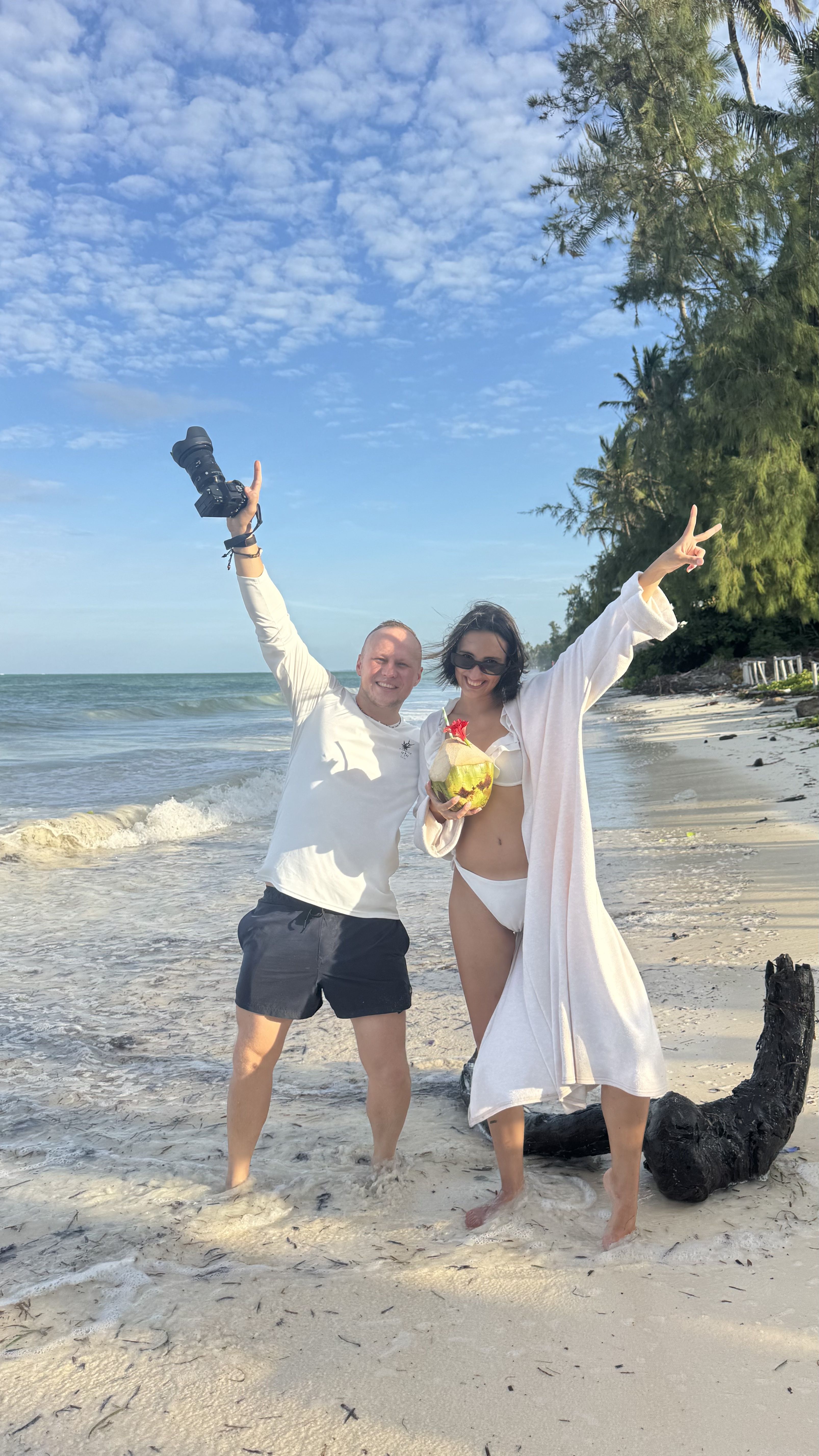 Happy couple celebrating on Zanzibar beach with photographer