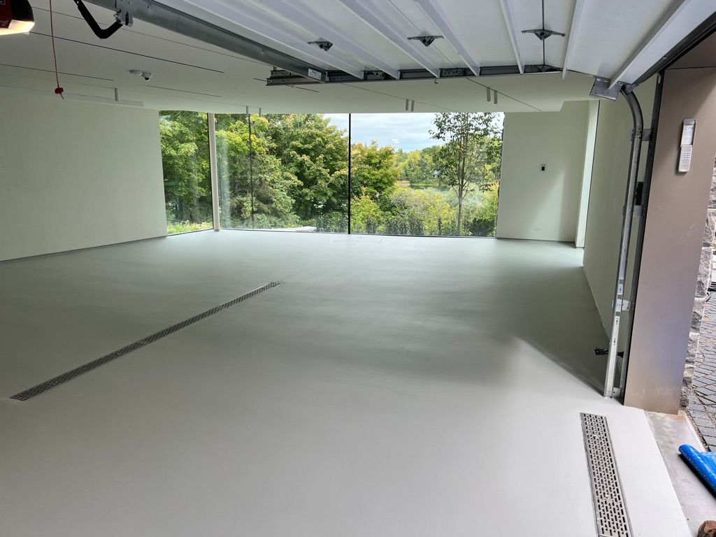 Residential garage with light sage seamless epoxy floor