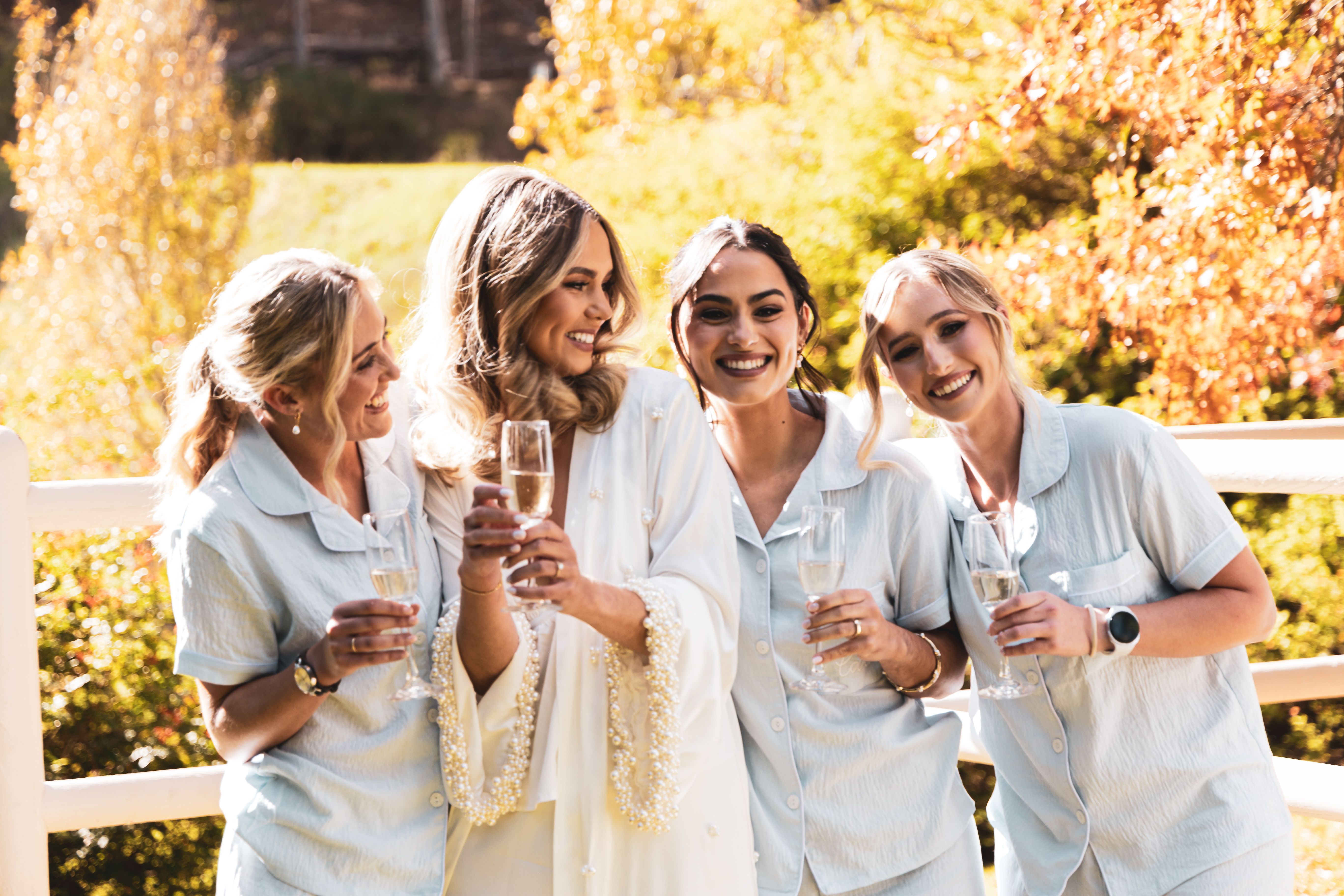 Bridesmaids celebrating with champagne