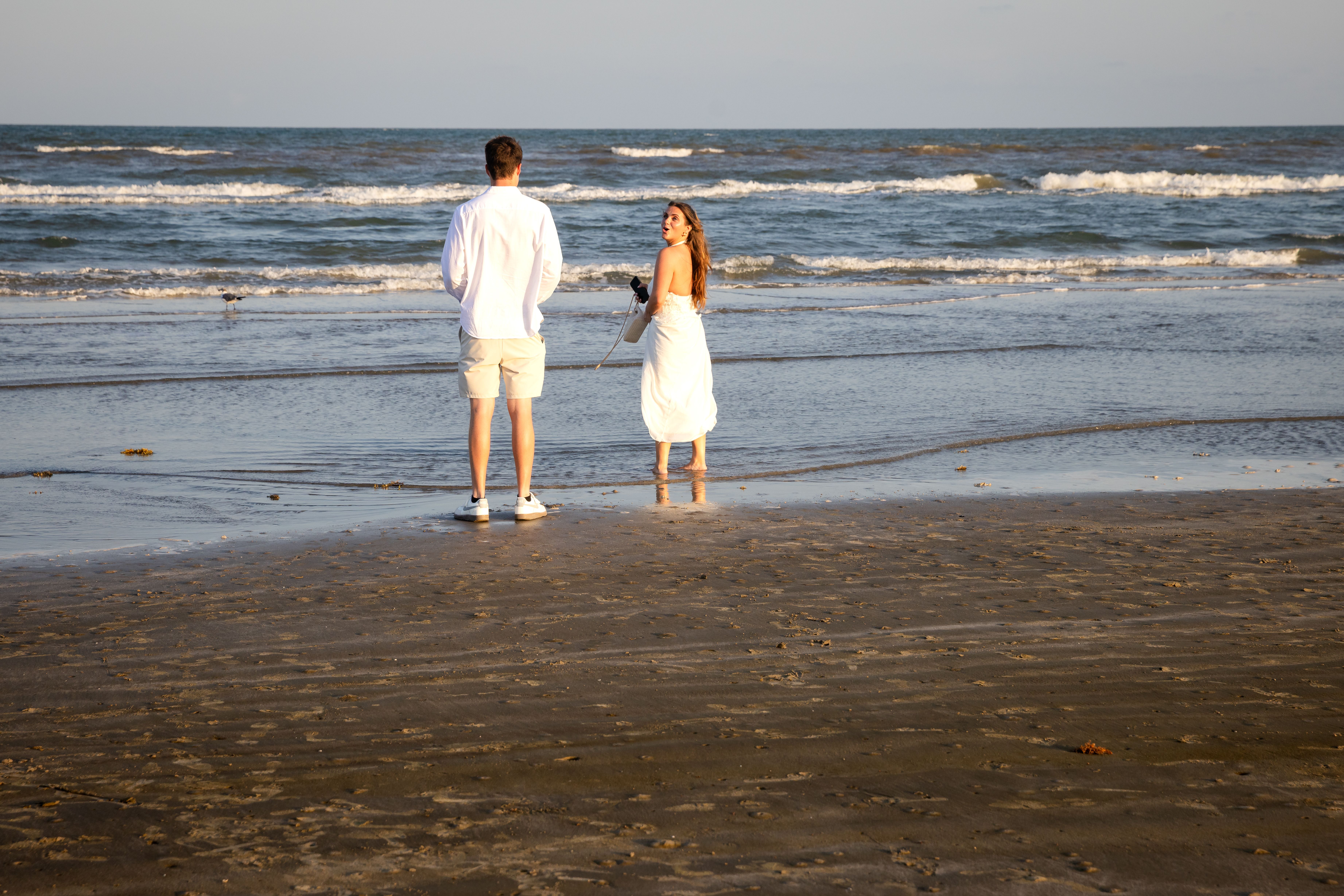 Couple standing at the ocean's edge