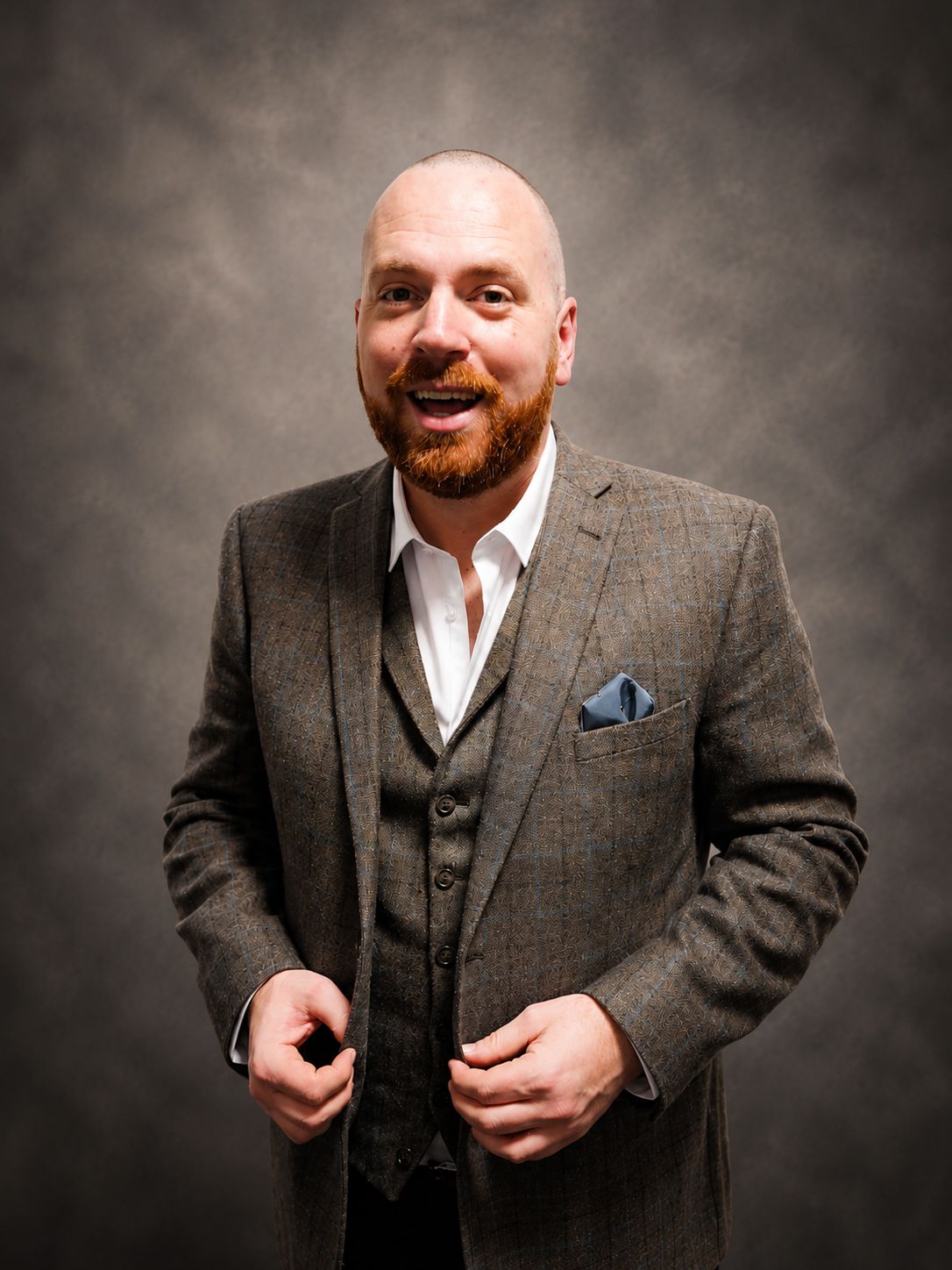 Ryan Wallace — The Opera Guy, professional portrait in a tailored three-piece suit