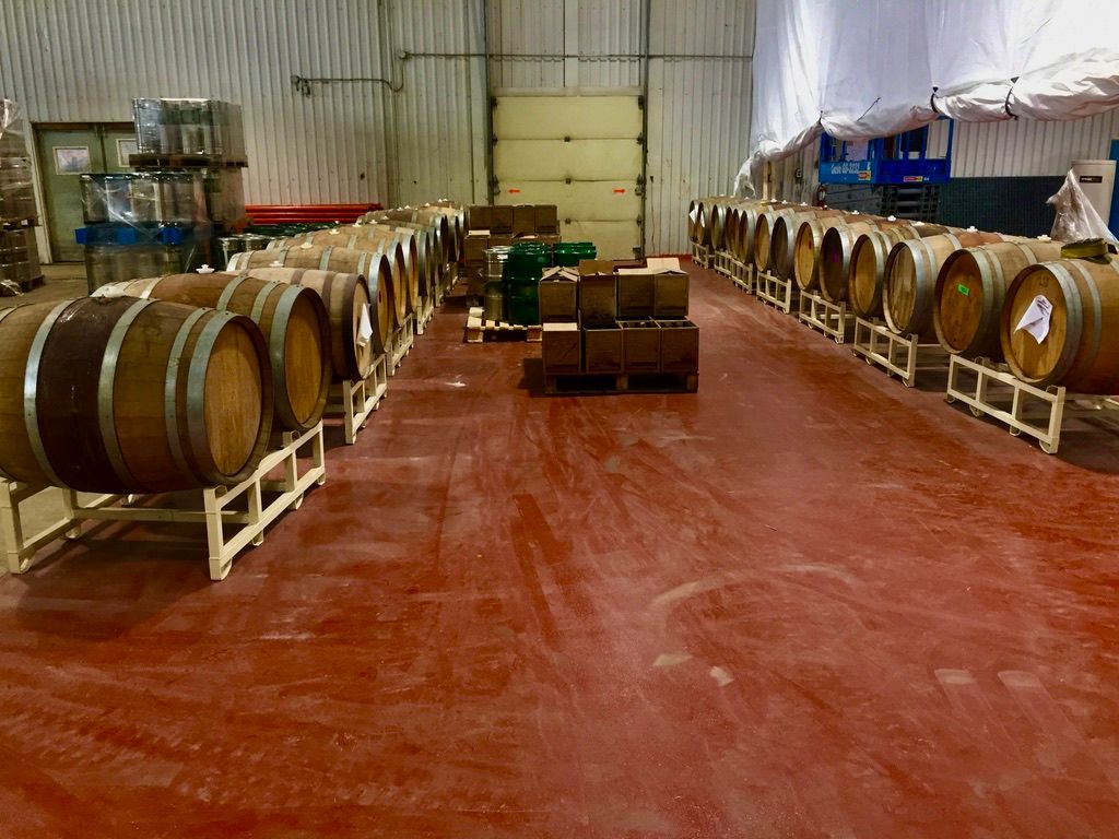 Winery barrel storage facility with seamless red epoxy floor