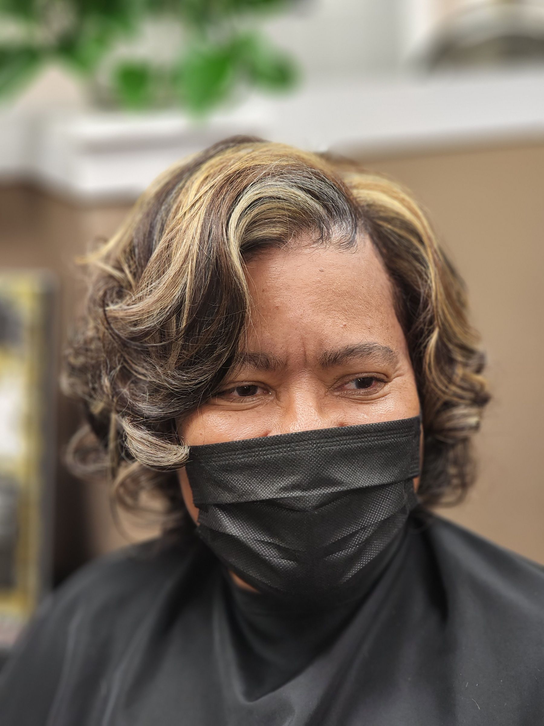Short curly hair with blonde highlights