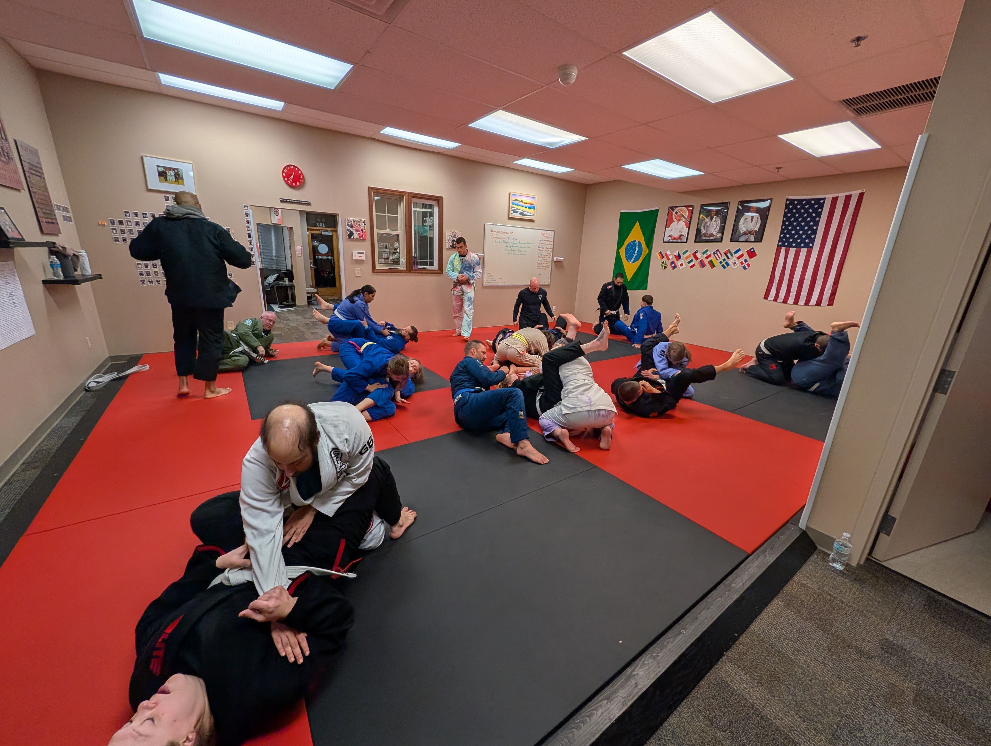 Aura Jiu Jitsu students training on the mats