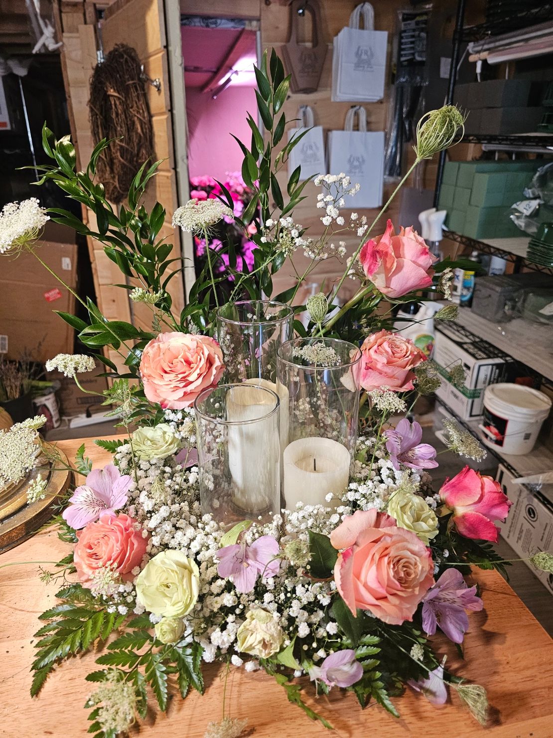Romantic roses with baby's breath and glass candle holders