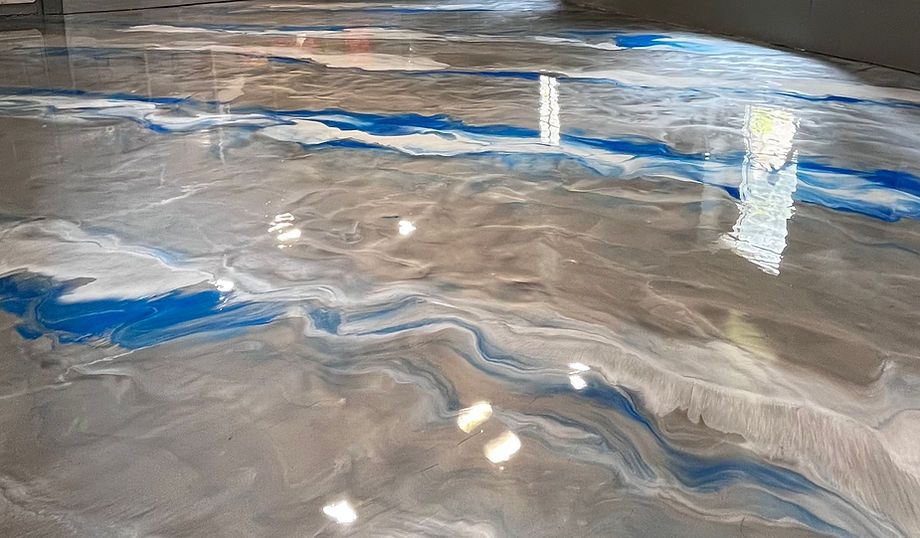 Gray and blue swirling metallic epoxy floor finish — basement installation