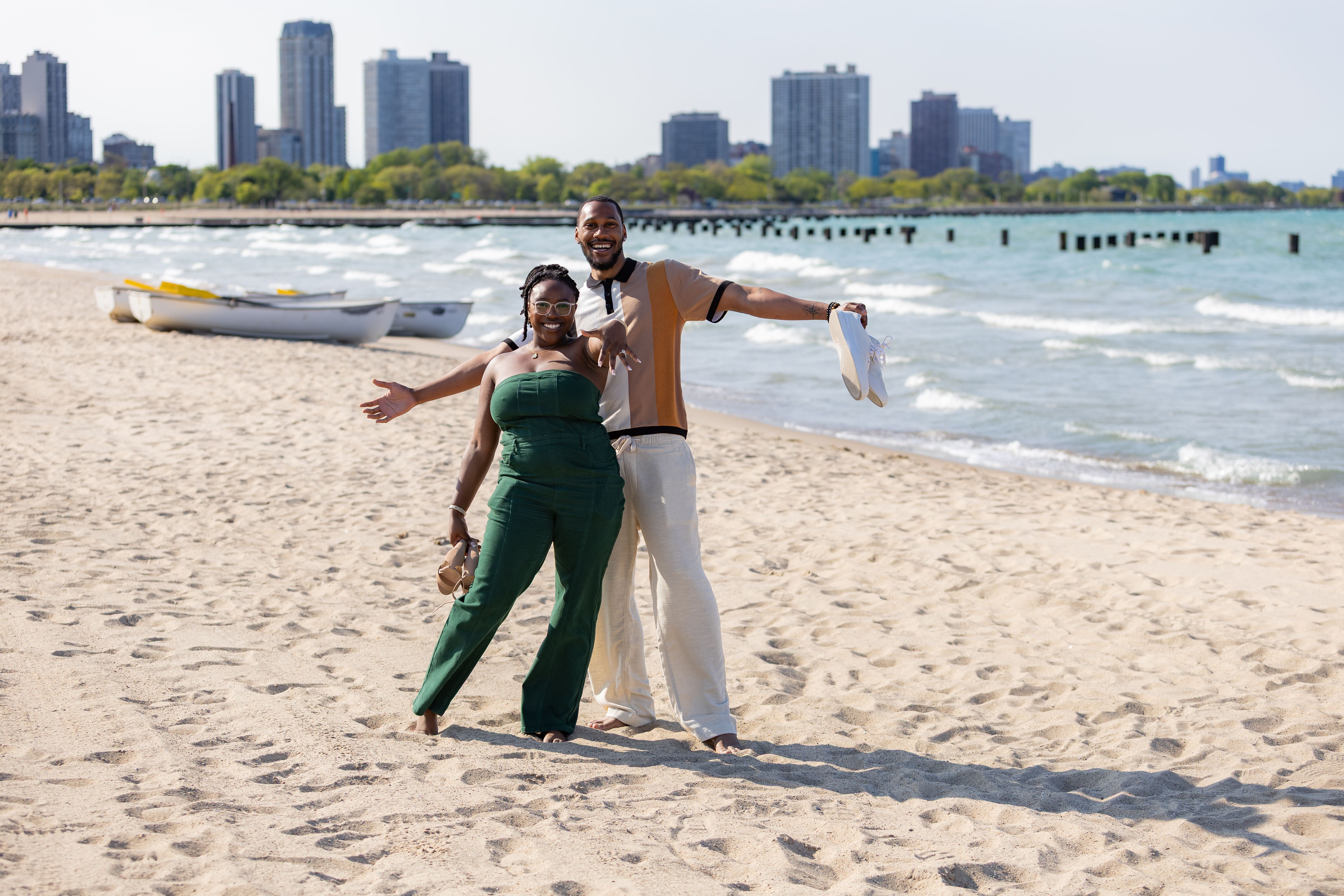Couple on lakefront beach with Chicago skyline in background