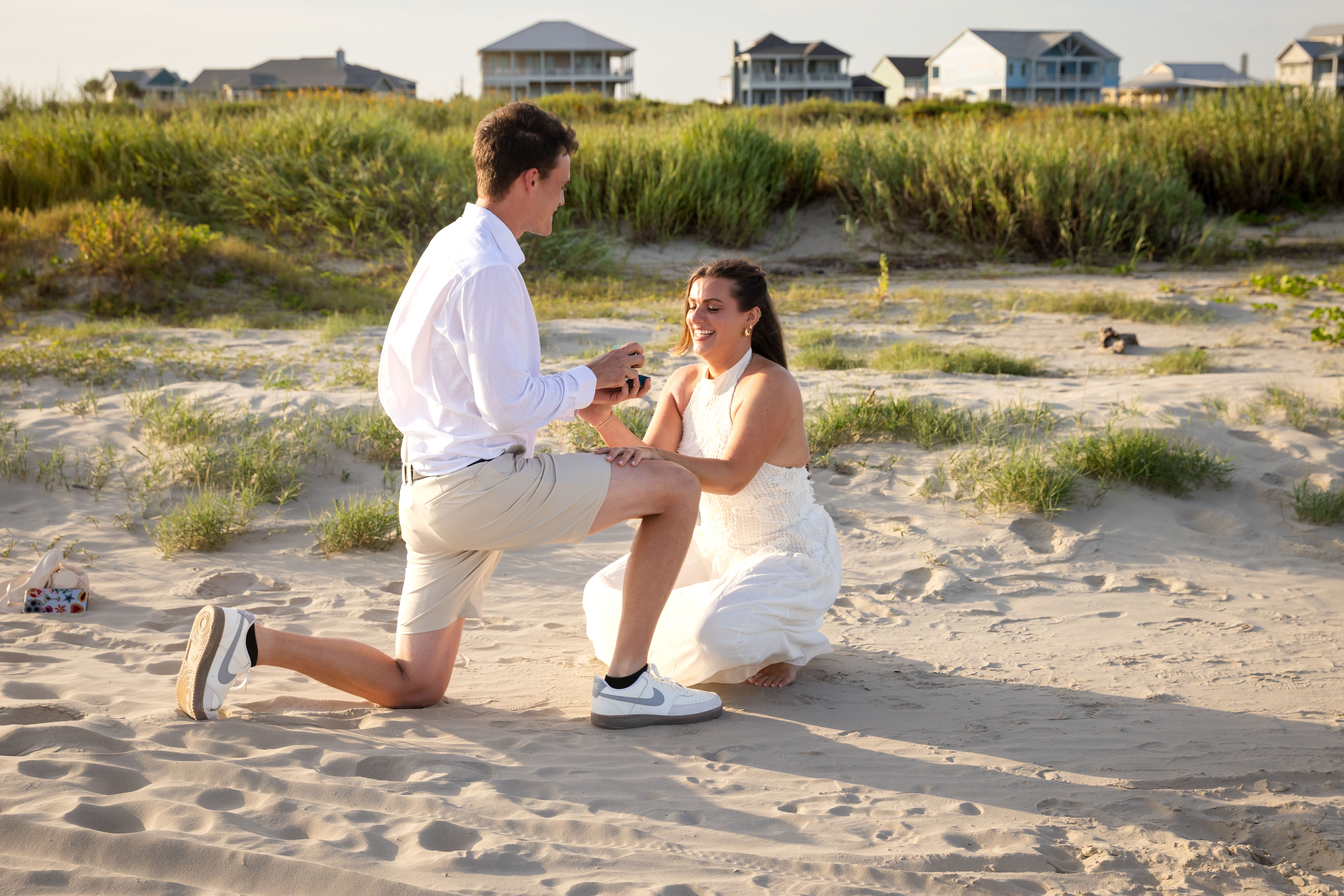 Beach proposal — couple moments after the yes