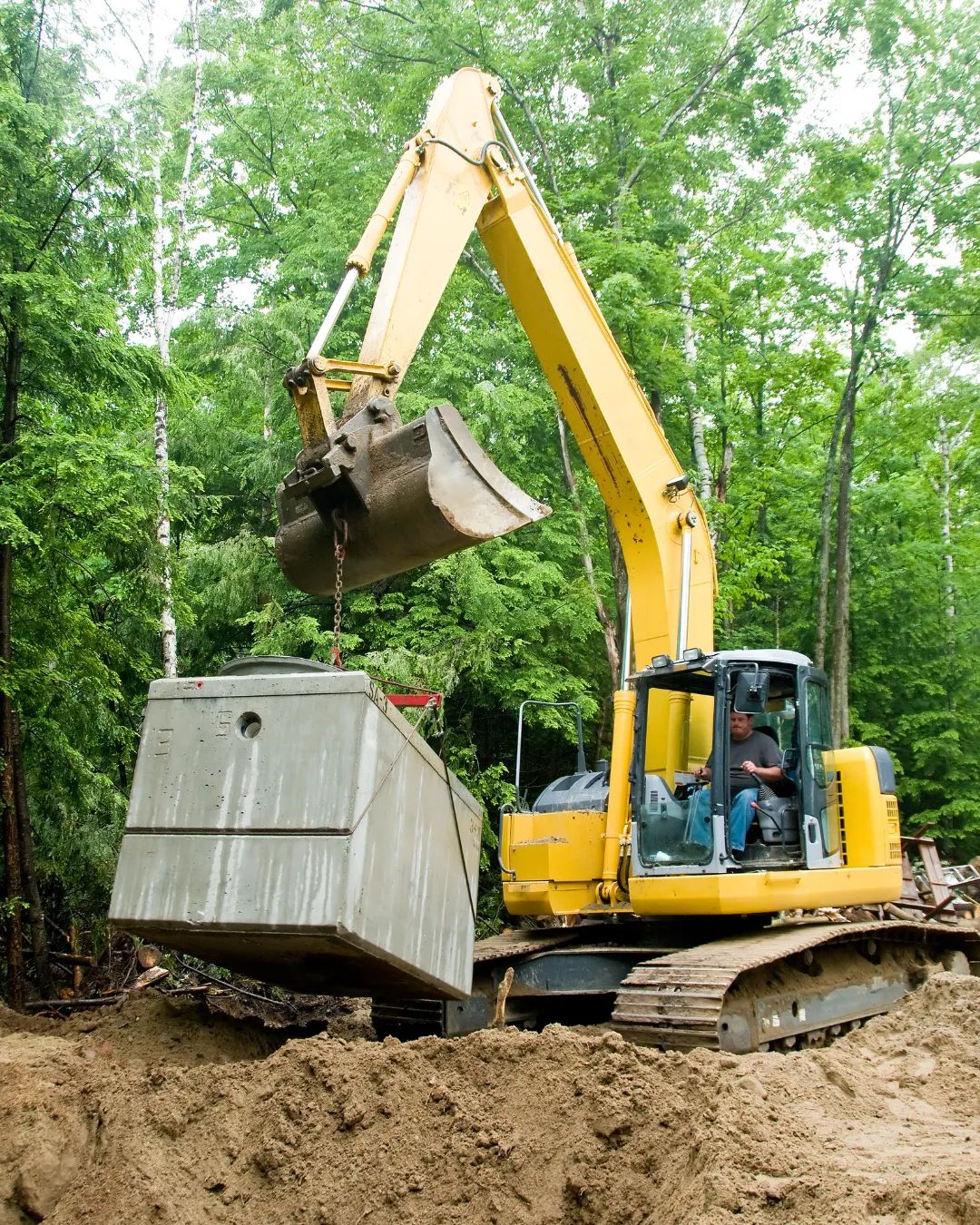 Excavator installing septic system