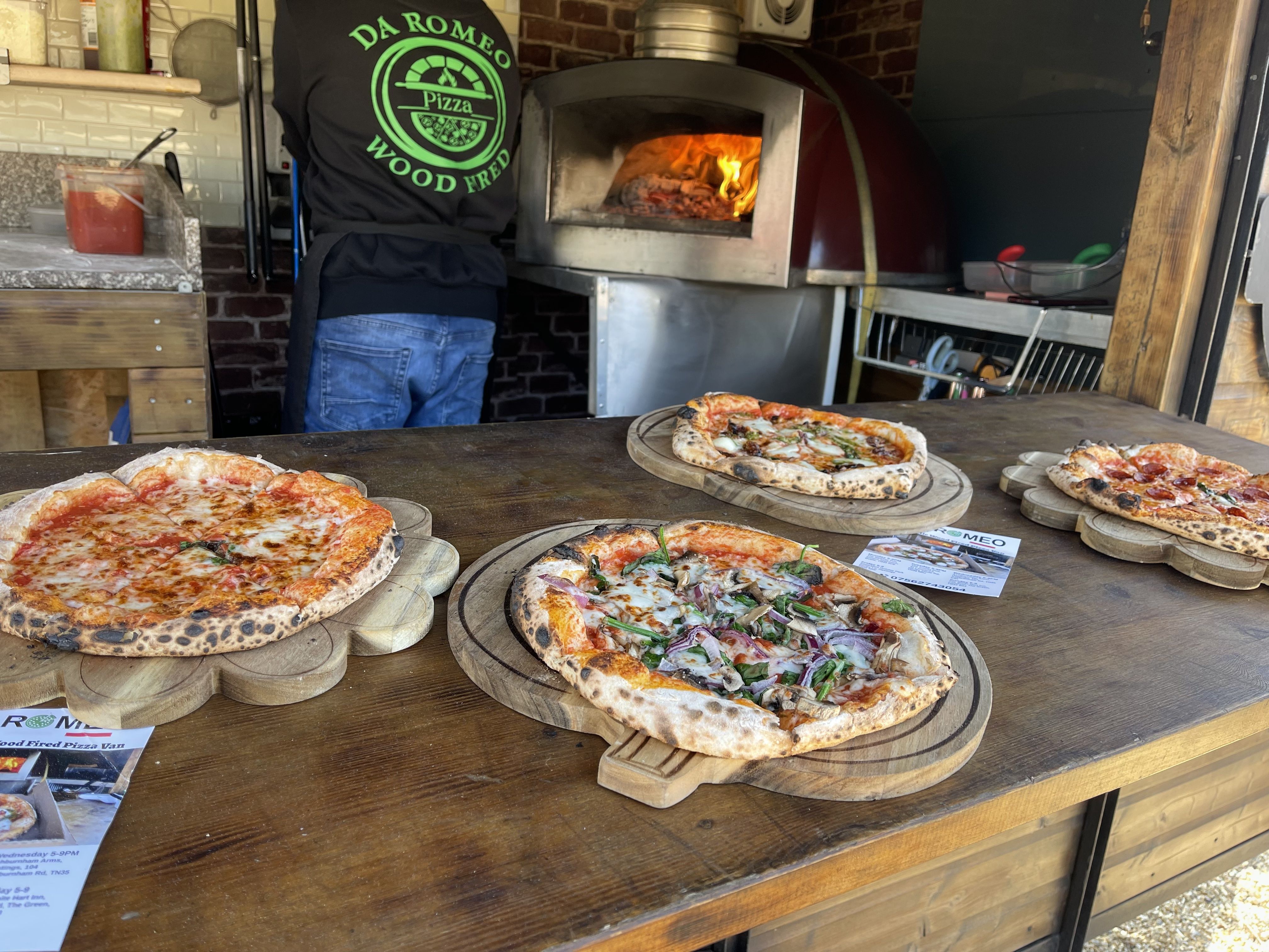Four wood-fired pizzas on display at The Comet pop-up