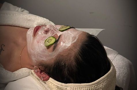 Natural herbal facial treatment with cucumber eye pads at Realuxe Wellness