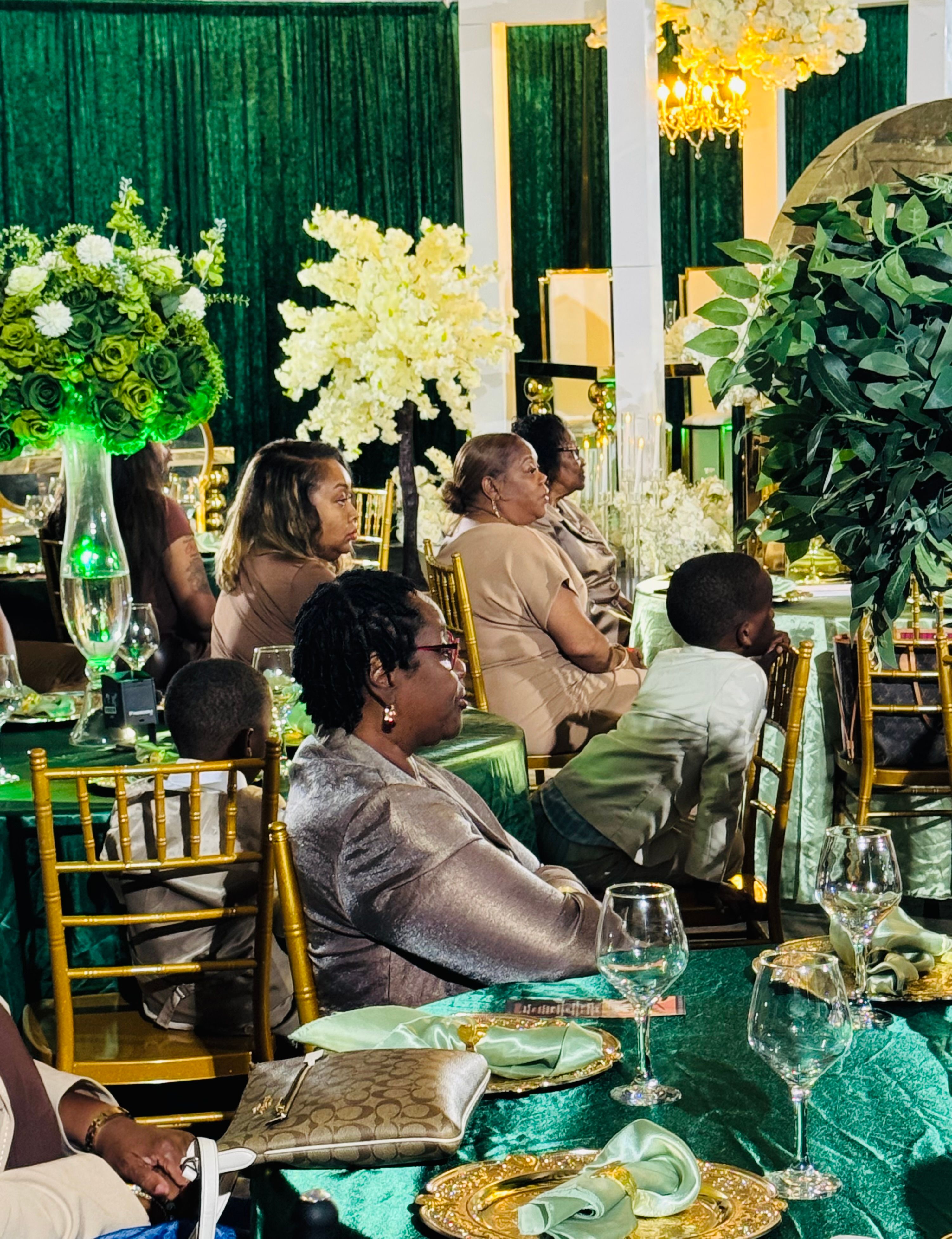 Green and white wedding reception with floral centerpieces