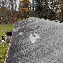 Roof with storm damage showing missing and damaged shingles Pittsburgh PA