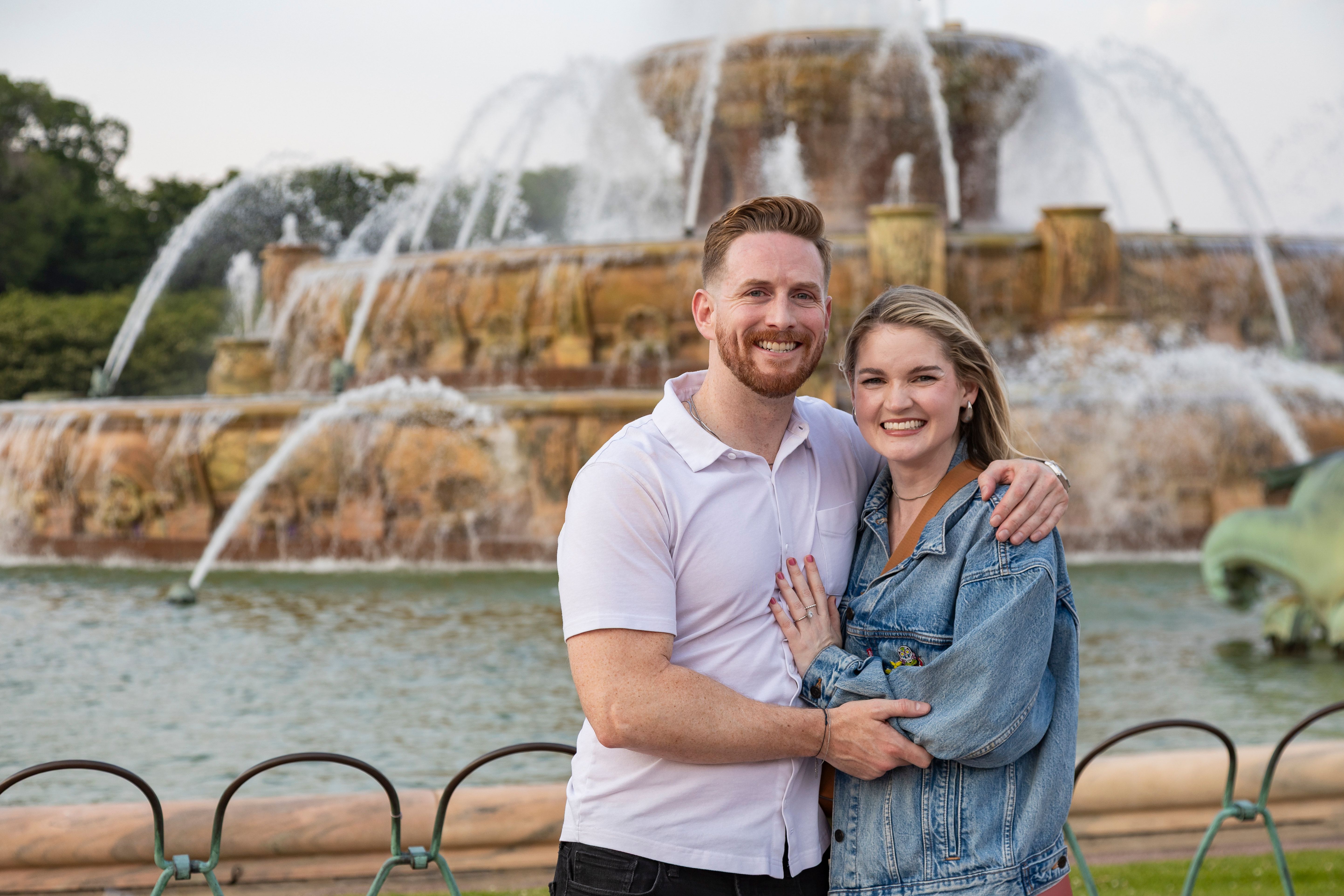 Couple celebrating engagement at Buckingham Fountain Chicago